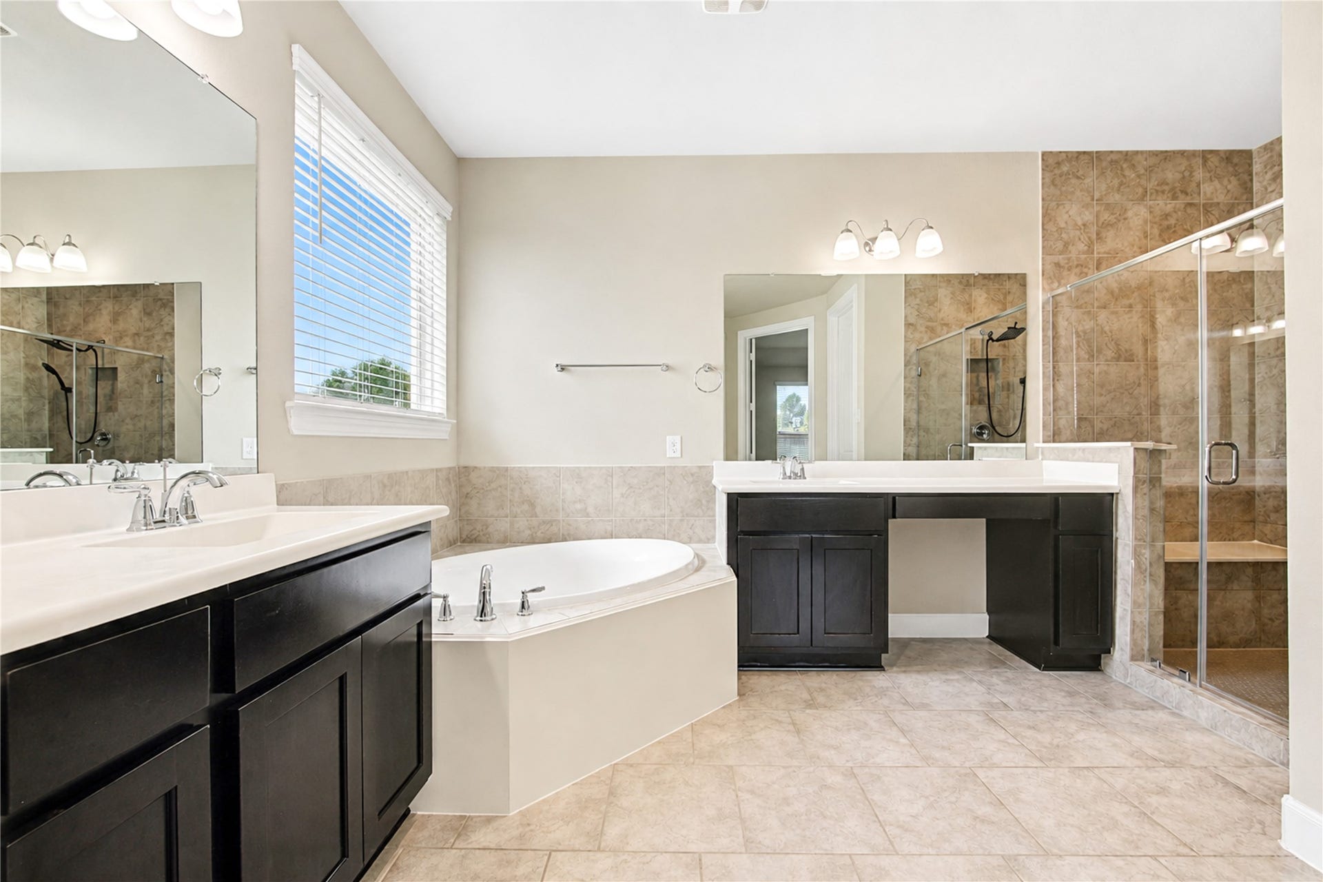 2334 Green Kale Drive, Richmond, TX 77406 The primary bathroom features a walk in closet, dual vanity sinks, soaking garden tub, large walk-in shower, separate water closet and walk-in closet.