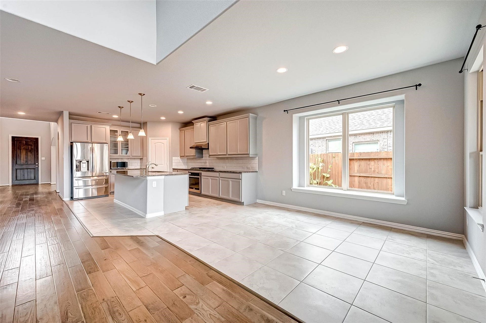 23514 San Ricci Court, Richmond, TX 77406 Open kitchen and breakfast area with plenty of natural light and views of the backyard.