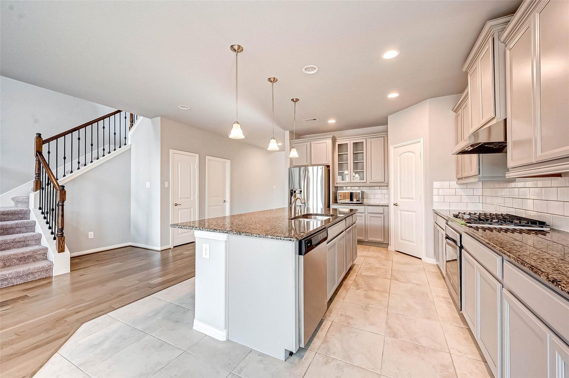 23514 San Ricci Court, Richmond, TX 77406 View from the breakfast area of the kitchen, highlighting the large center island, granite countertops, and open layout.