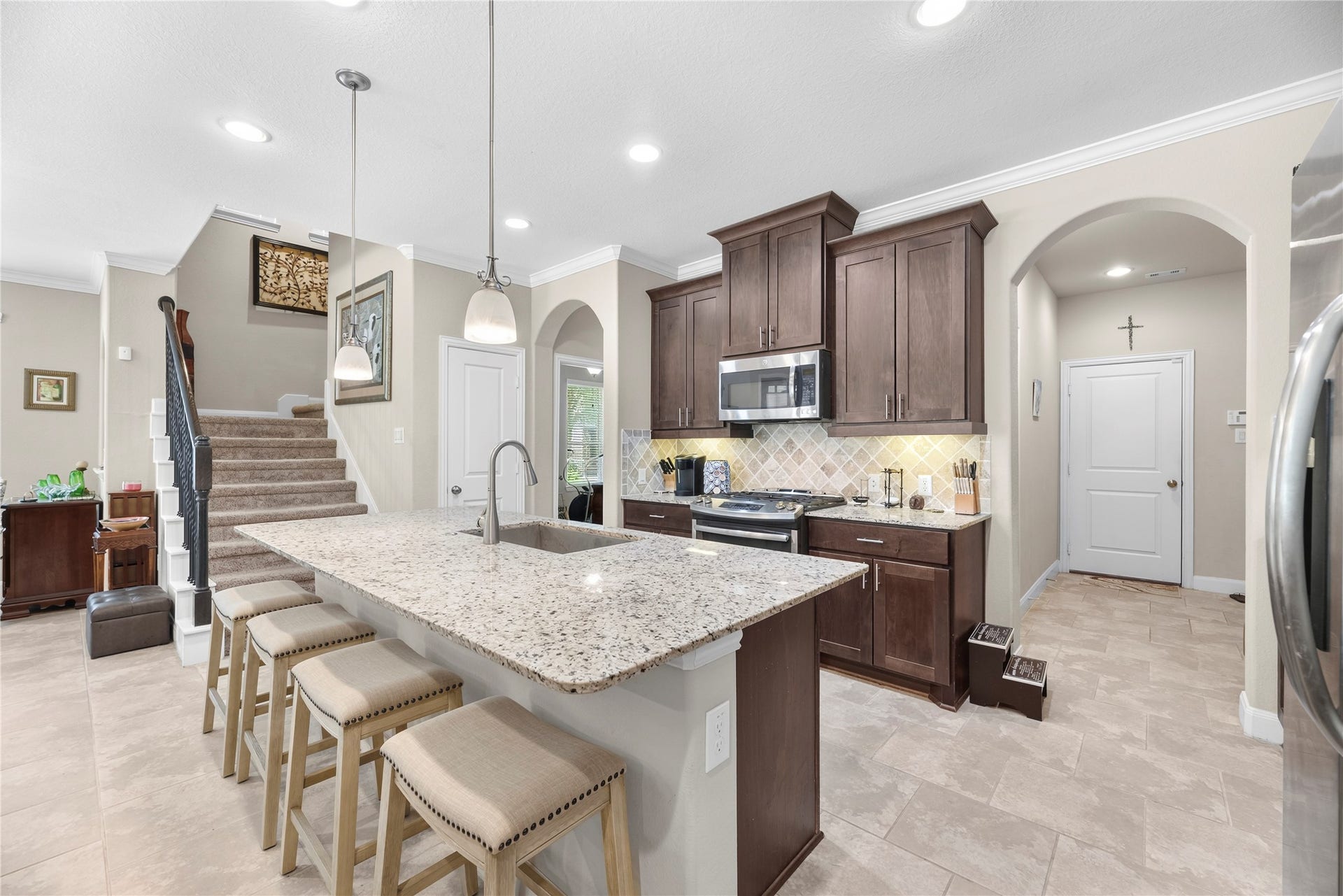 Wonderfully equipped kitchen with an abundance of countertop space and cabinetry, recessed lighting, stainless steel appliances and more.