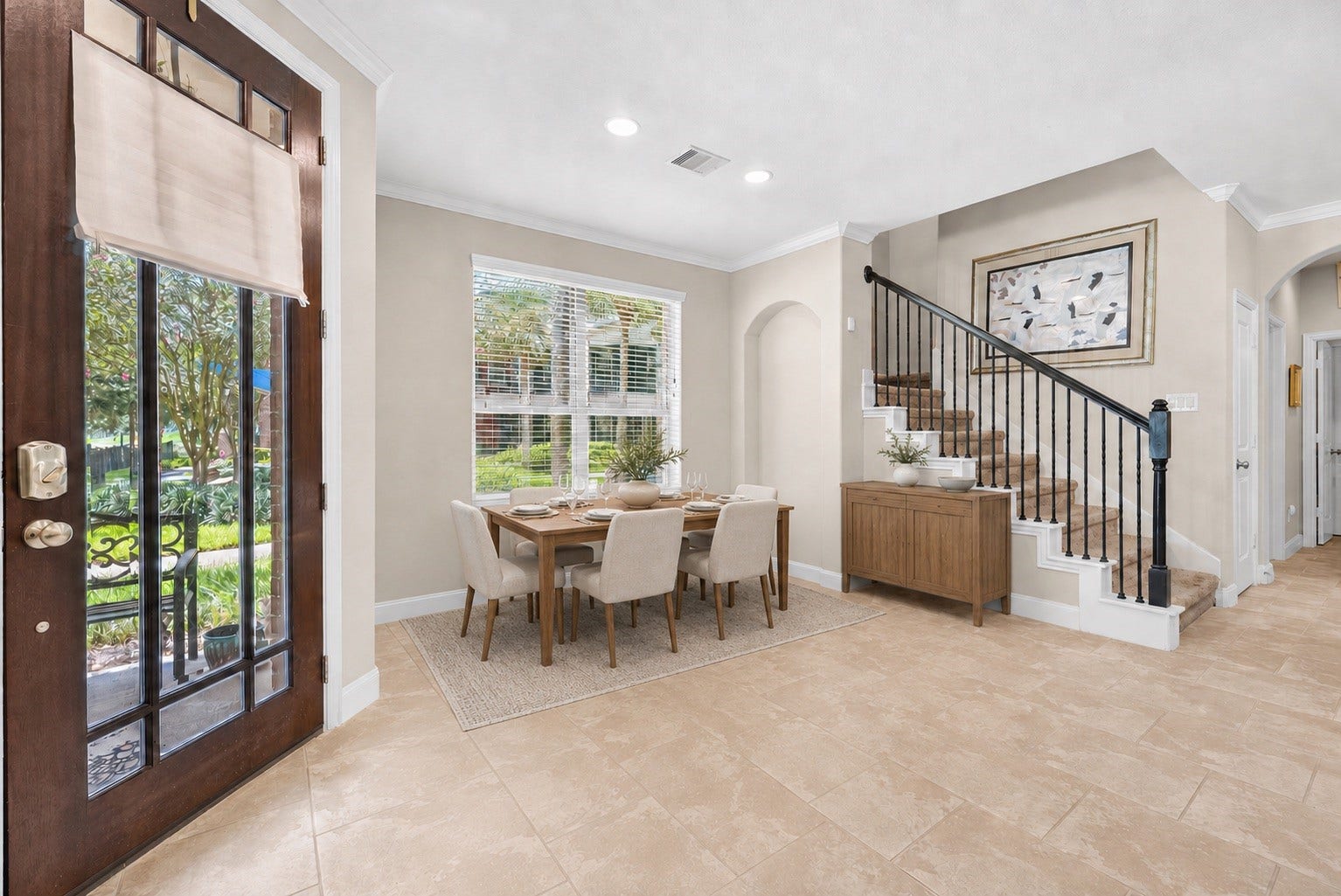 *virtually staged* dining room with large windows and beautiful tile floors.