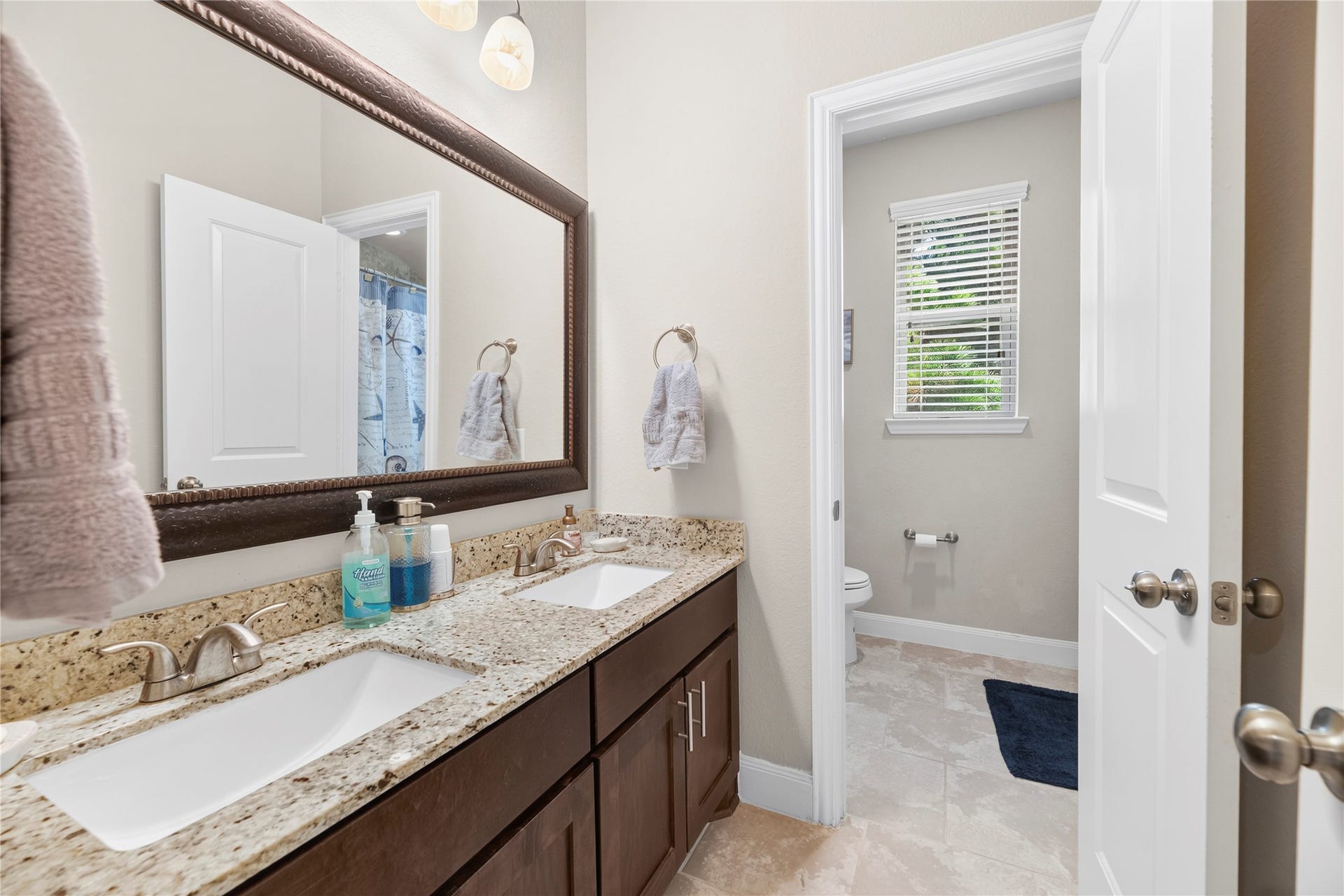 Secondary bathroom located on the 2nd floor with a shower/tub combo and double sink vanity.