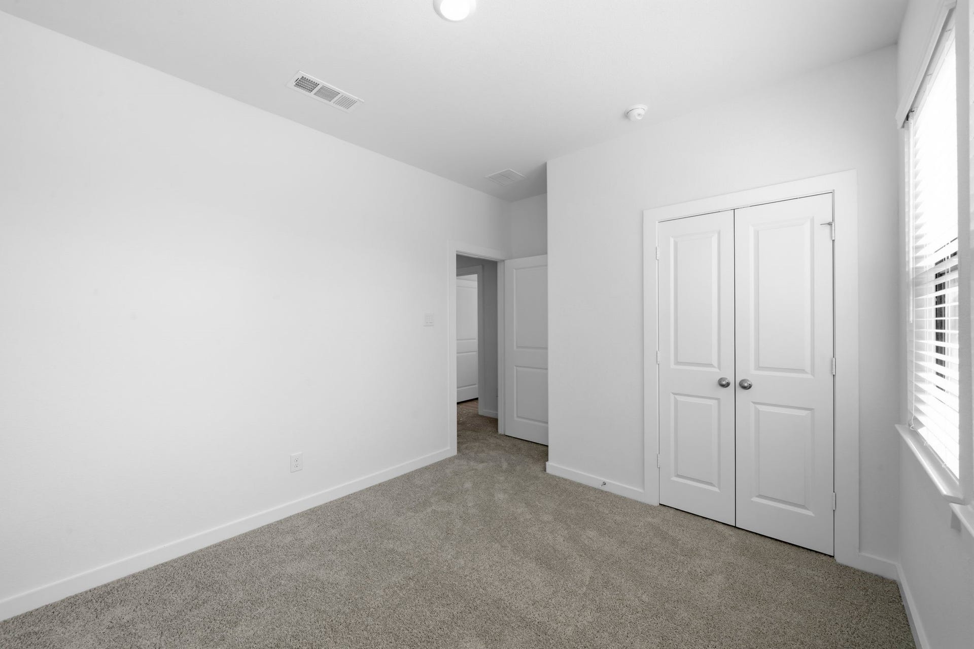 3317 City Heart Avenue, Richmond, TX 77406 The second upstairs bedroom offers a comfortable retreat with plush carpeting, a spacious double-door closet, and a bright, neutral backdrop. With plenty of room to personalize, this inviting space is ready to become your own.