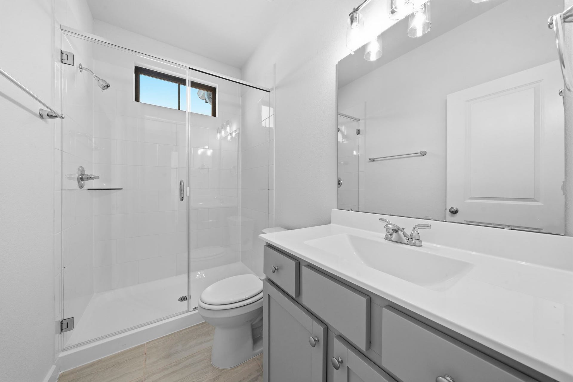 3317 City Heart Avenue, Richmond, TX 77406 The upstairs bathroom continues the homes modern, sleek feel with a spacious walk-in glass shower, clean finishes, and a large vanity. A well-placed window brings in natural light, creating a bright and refreshing space.
