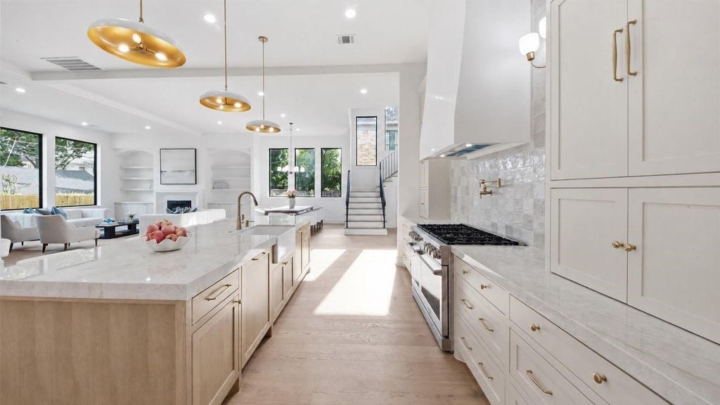 view of extensive kitchen storage with views into the living room and dining room perfect for entertianing and families
