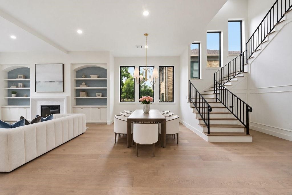 Dinning room with nightlines into the living room and grand staircase