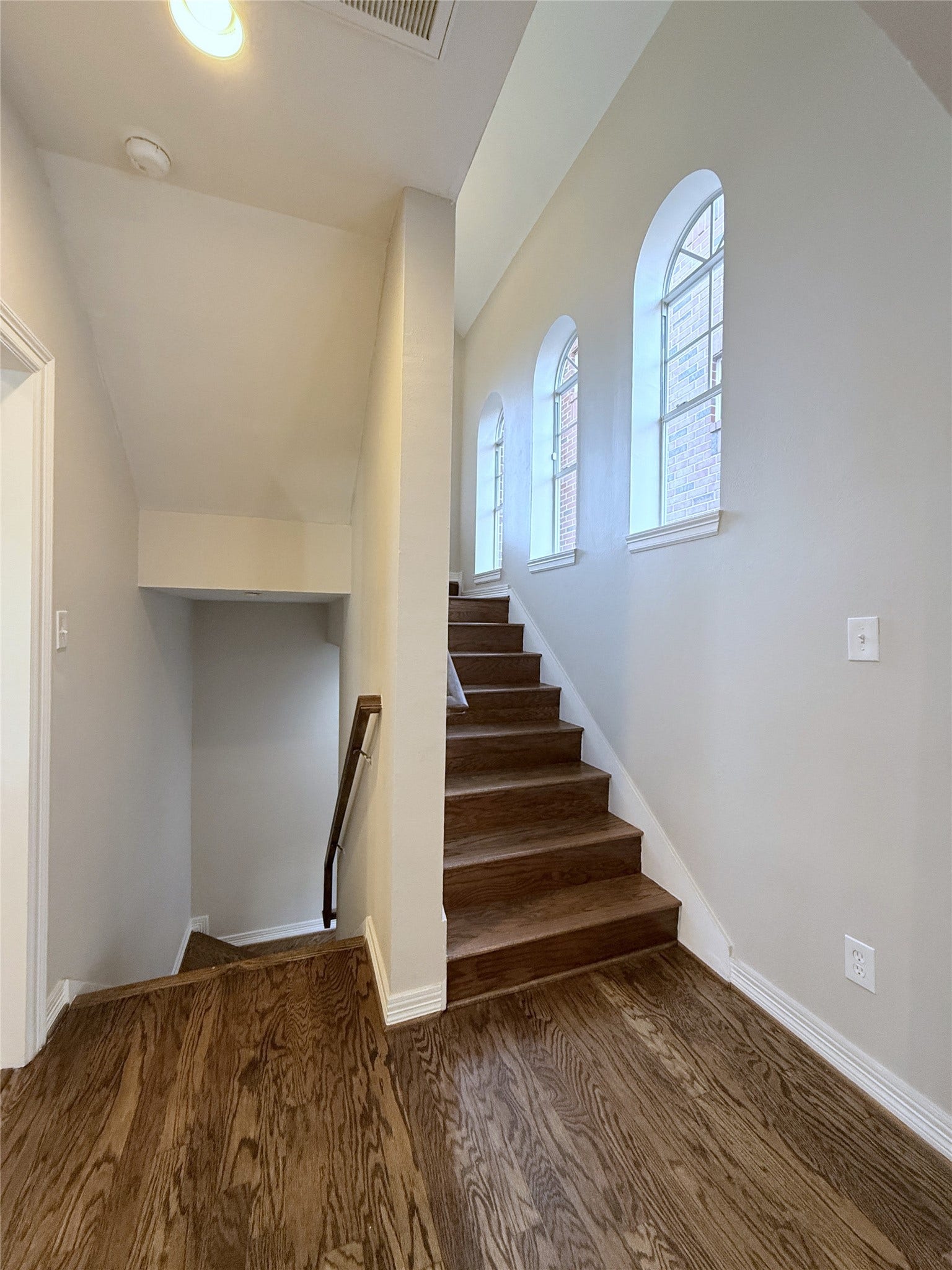 1963 Peden Street, Houston, TX 77019 In the stairway to the 3rd floor, natural light flows in from arched windows.
