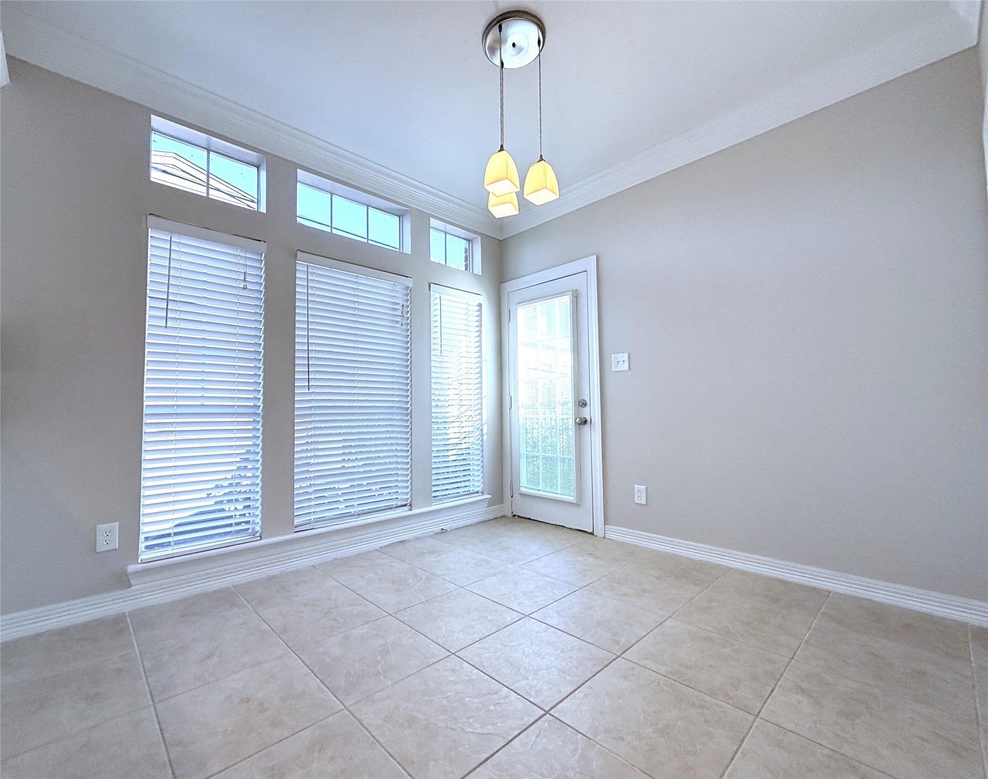 1963 Peden Street, Houston, TX 77019 From tri-windows, natural light flows into the breakfast room. The glassed paned door opens in from the spiral stairway leading down to the backyard.