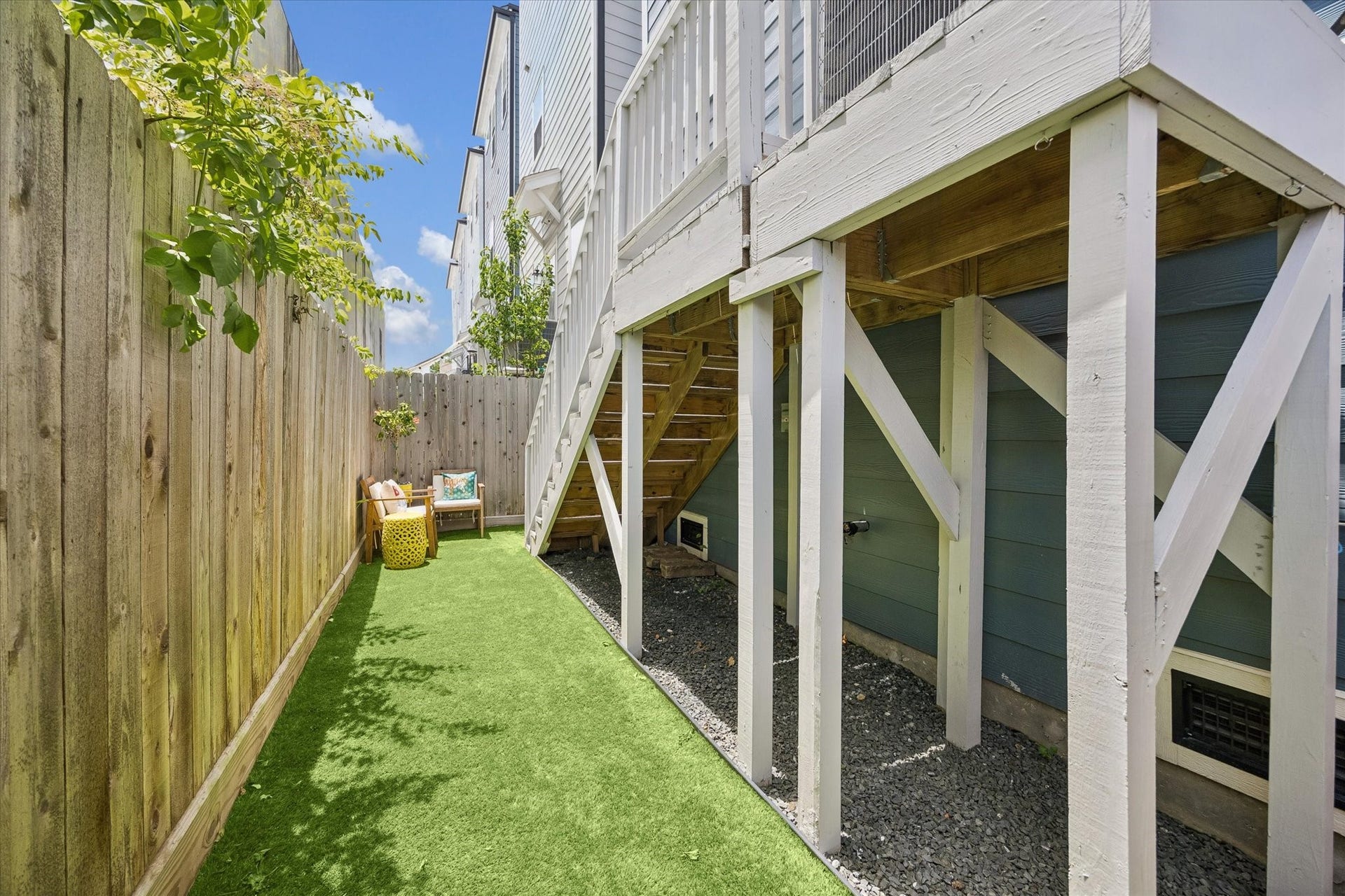 1226 W 21st Street, Houston, TX 77008 The fenced yard offers a practical extension of the home with artificial turf, deck access, and just enough space to enjoy the outdoors with ease.