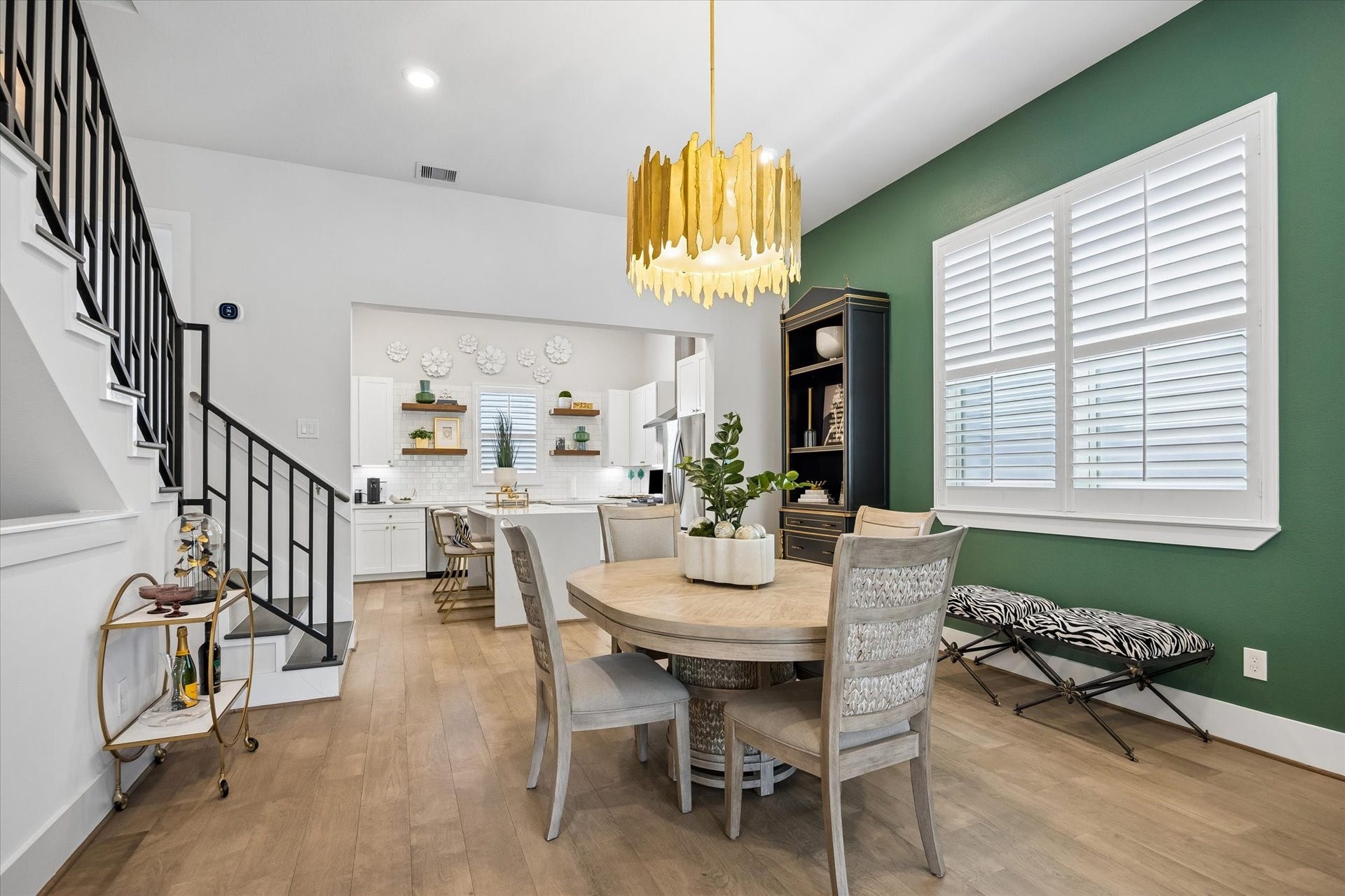1226 W 21st Street, Houston, TX 77008 This dining area blends style and function together beautifully with engineered wood flooring, wood shuttered windows, designer lighting, and an easy connection to the island kitchen and living area.