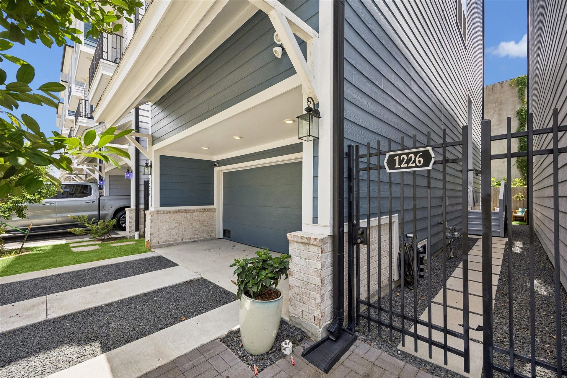 1226 W 21st Street, Houston, TX 77008 A gated side entry, private driveway, 2-car garage, and modern exterior details give this home a polished arrival that feels both stylish and secure.