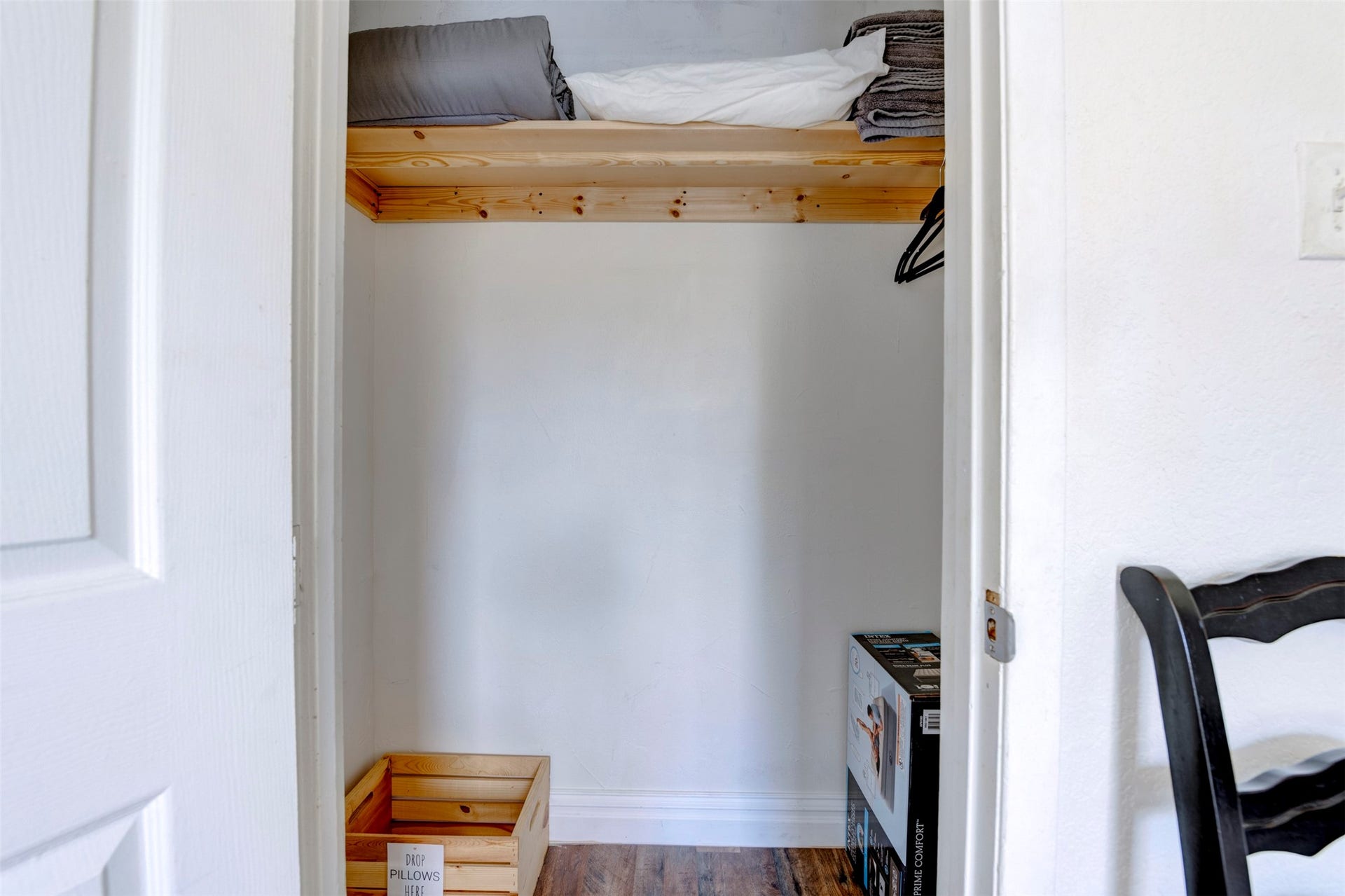 1121 Panama Street, #B, Houston, TX 77009 Spacious closet with natural pine wood upper shelf, hanging rod, freshly painted white walls, and wood-look flooring throughout.