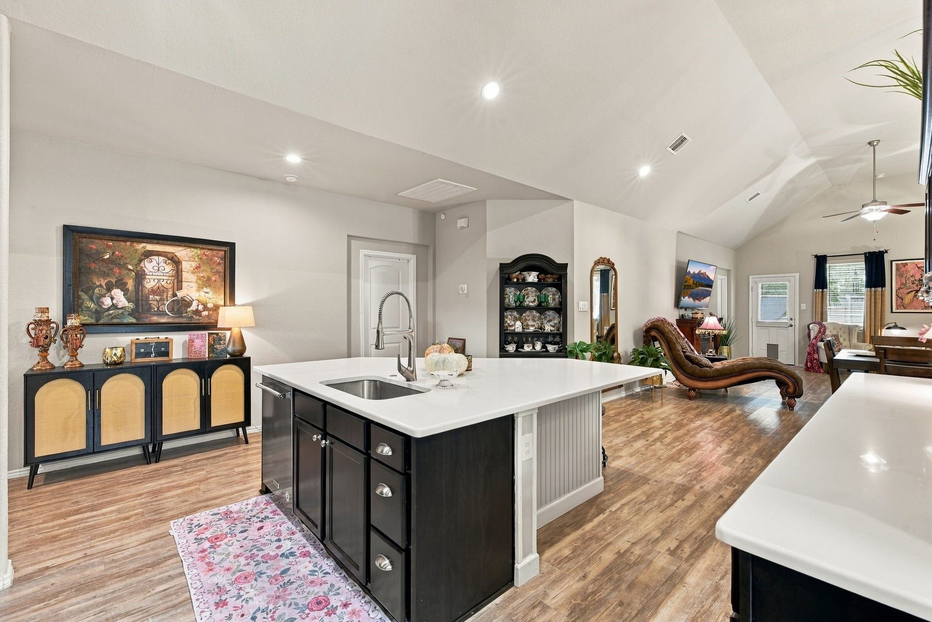 11371 Dawn Beach Lane, Conroe, TX 77304 Spacious open-concept living area with elegant kitchen island, vaulted ceilings, and stylish decor, perfect for entertaining and relaxation.