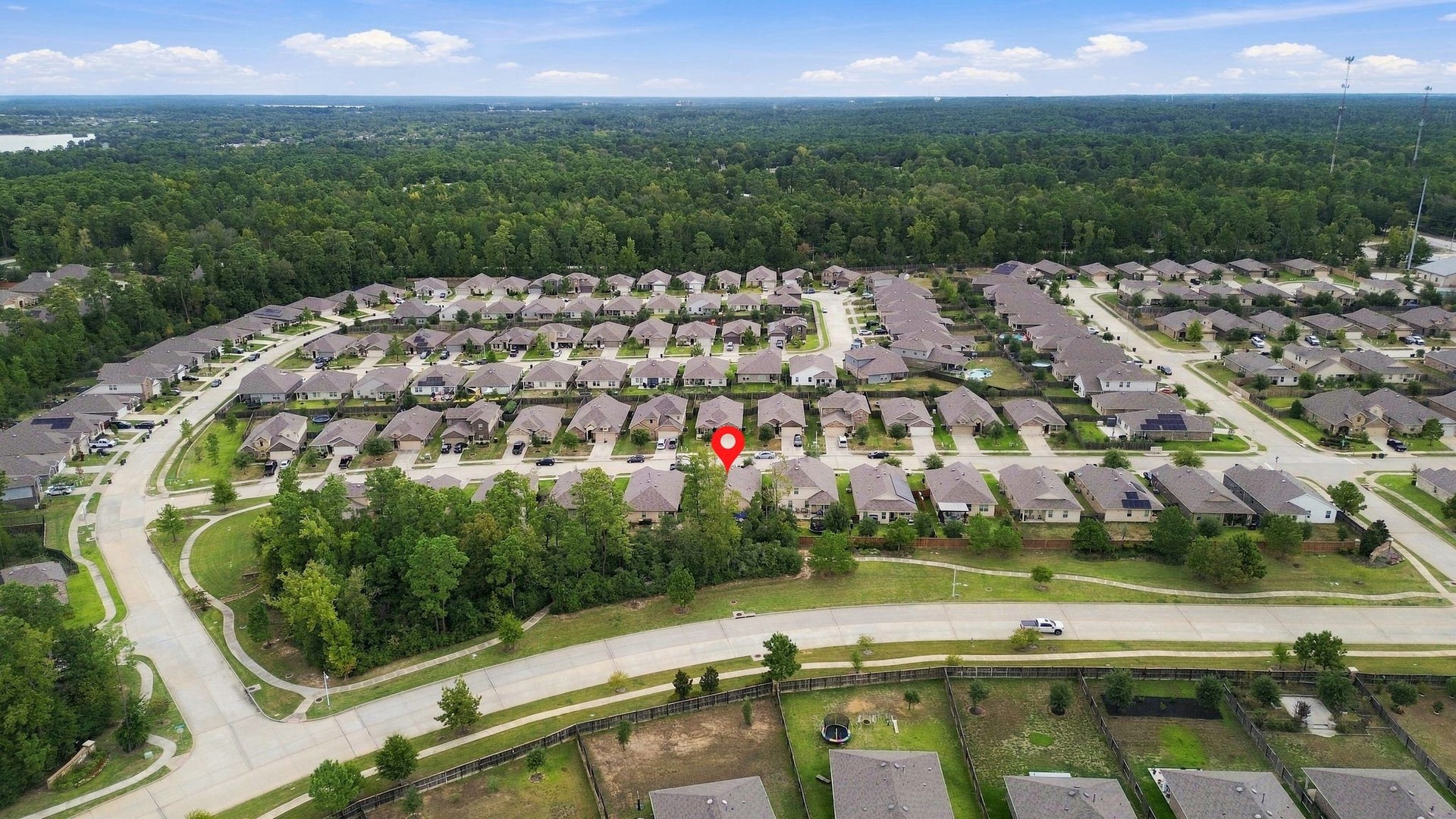 11371 Dawn Beach Lane, Conroe, TX 77304 Nestled in a serene neighborhood, this home offers lush green surroundings and convenient access to winding roads, perfect for a peaceful lifestyle.
