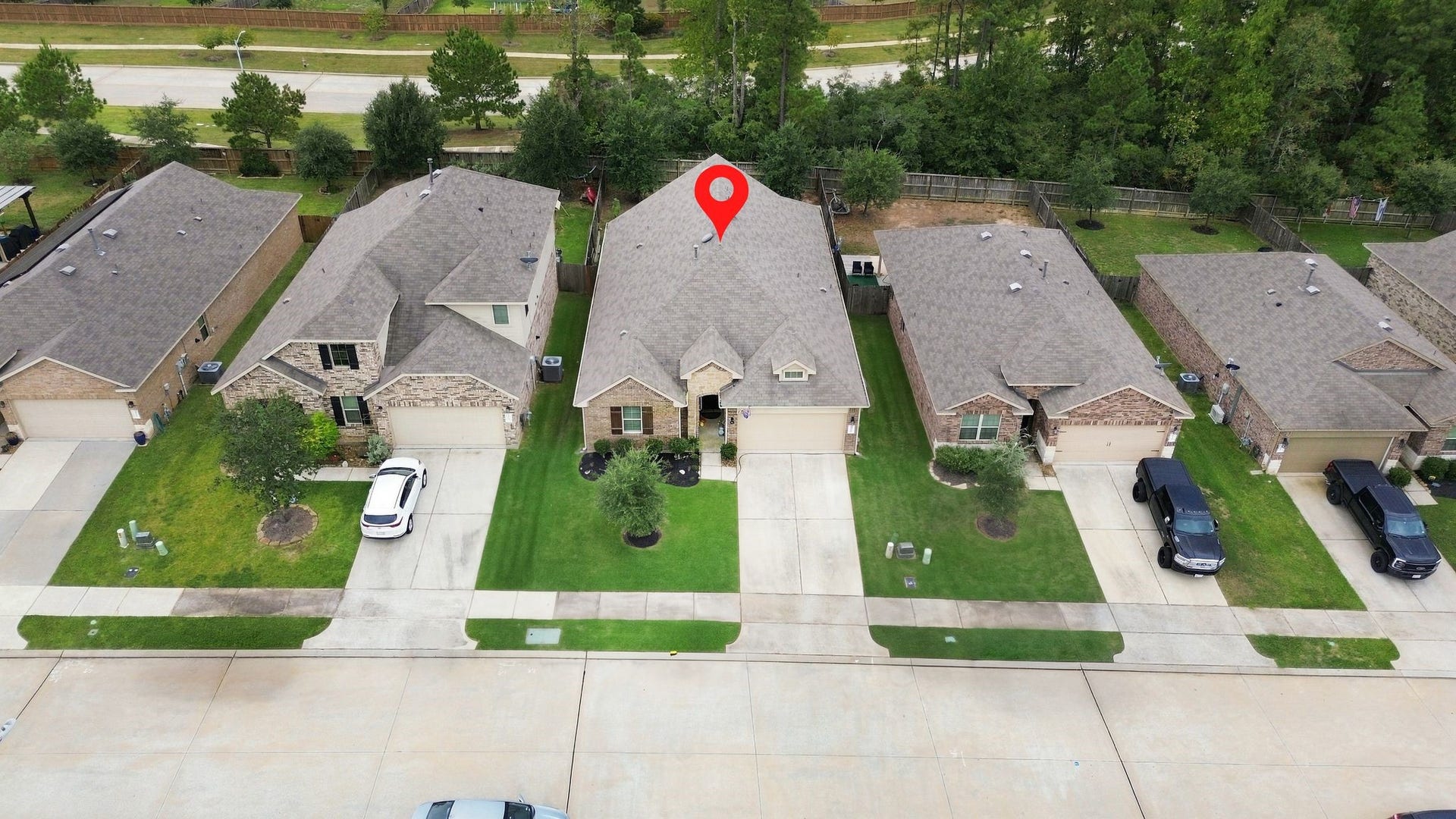 11371 Dawn Beach Lane, Conroe, TX 77304 Charming single-story home with a well-maintained front yard and spacious driveway, nestled in a quiet neighborhood.