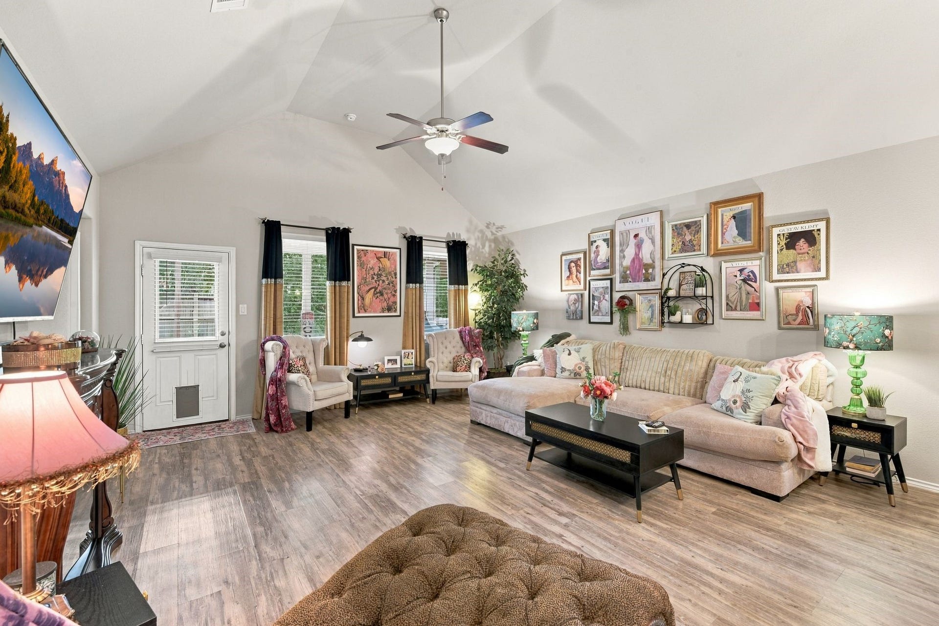 11371 Dawn Beach Lane, Conroe, TX 77304 Spacious living room with vaulted ceilings and abundant natural light, featuring elegant decor and a cozy seating area perfect for entertaining.