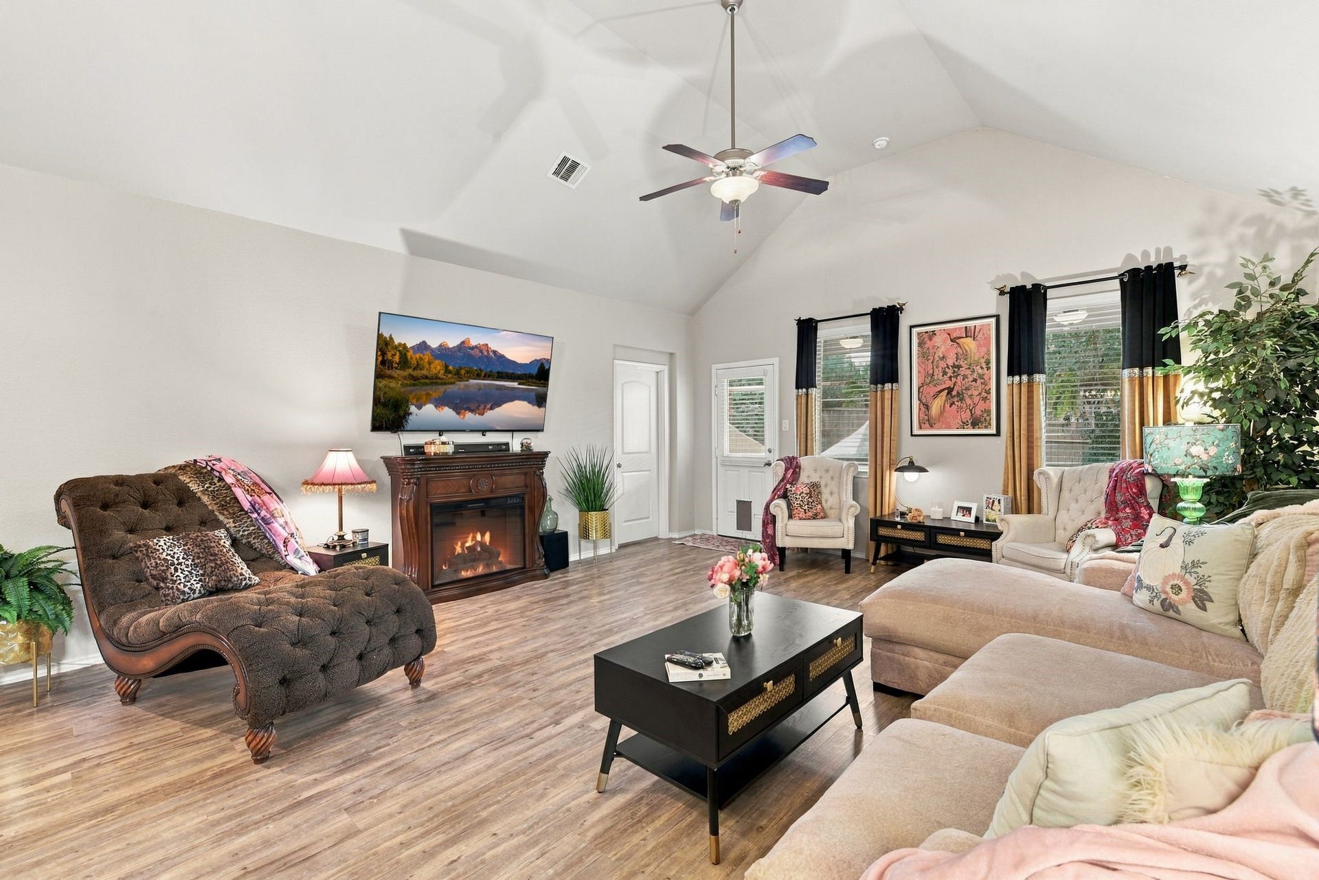 11371 Dawn Beach Lane, Conroe, TX 77304 Spacious living room with vaulted ceilings, elegant flooring, and abundant natural light, featuring a cozy fireplace and stylish seating area.