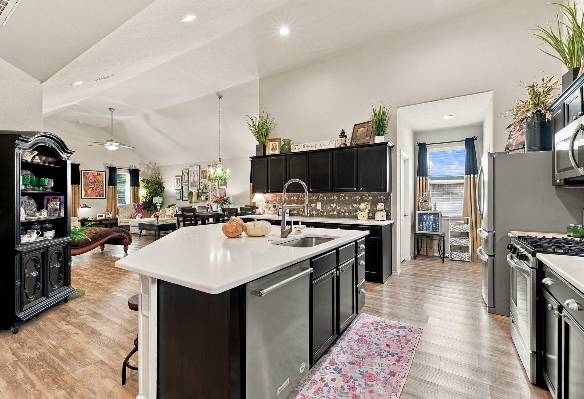 11371 Dawn Beach Lane, Conroe, TX 77304 Spacious open-concept kitchen and living area featuring a large island with modern stainless steel appliances, elegant cabinetry, and abundant natural light, all seamlessly connecting to a cozy dining and living space.