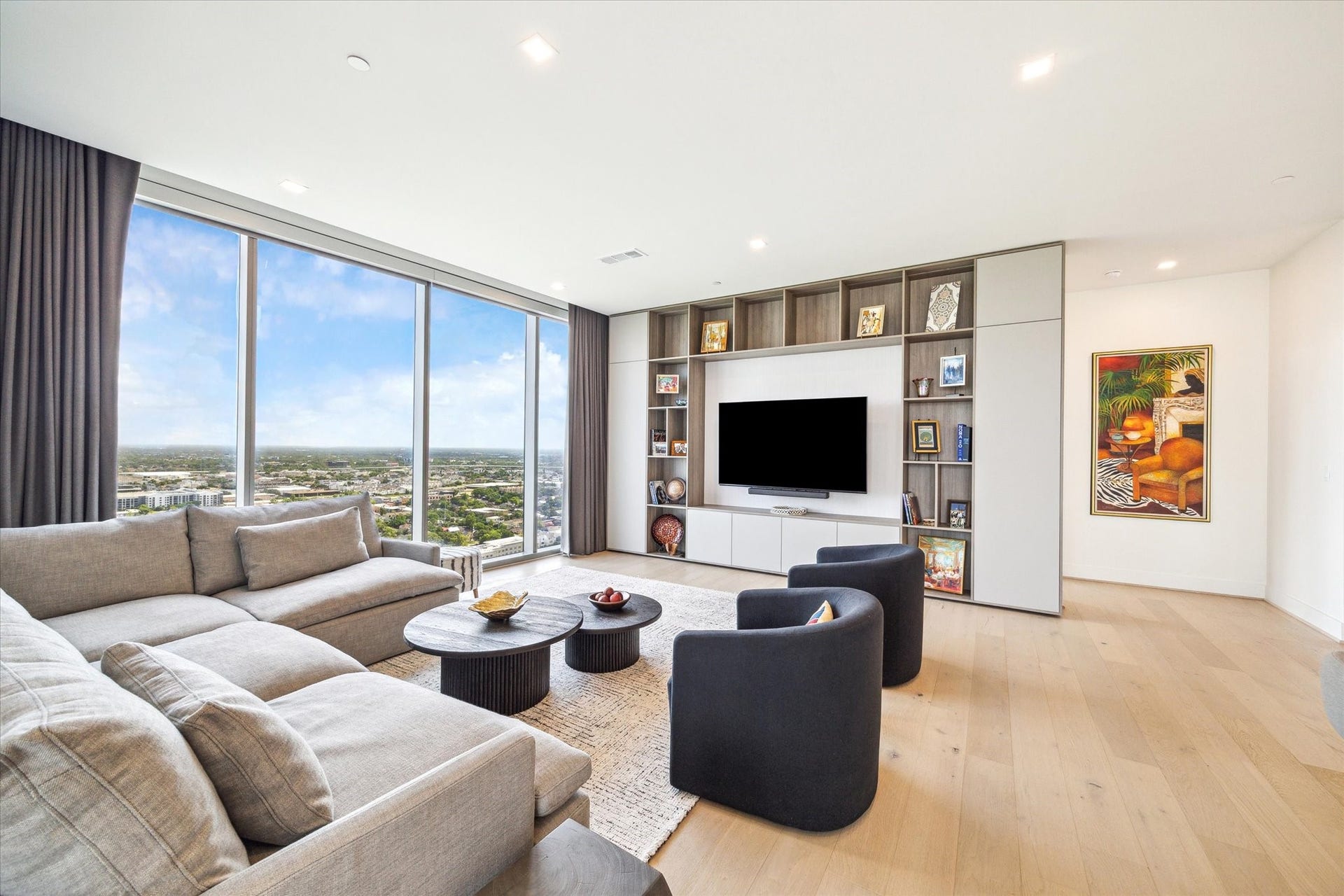 1711 Allen Parkway, #2601, Houston, TX 77019 Clean unobstructed views of the city and wonderful ability to display your art with a full wall of built-ins with storage cabinets.