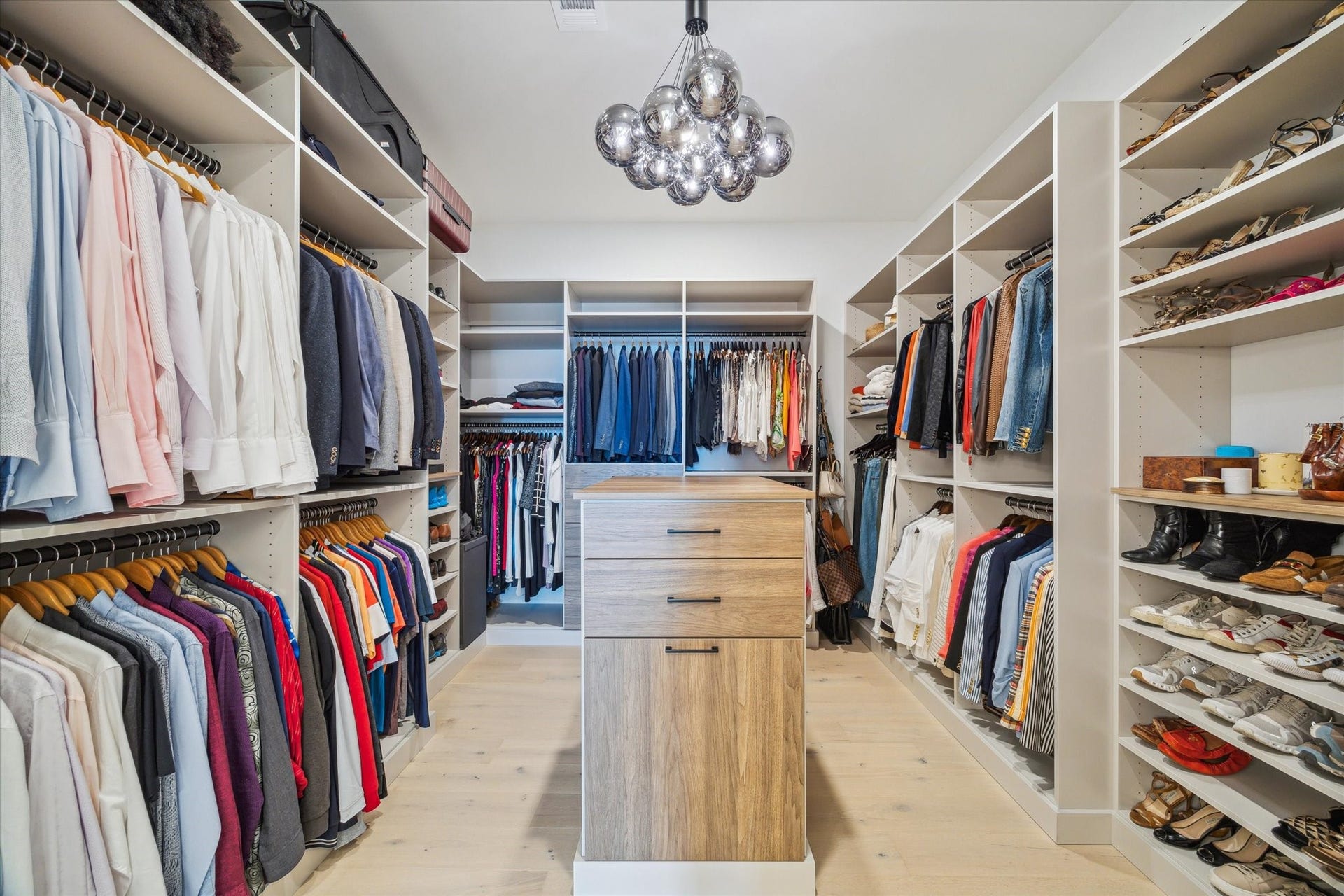 1711 Allen Parkway, #2601, Houston, TX 77019 Primary closet custom designed and installed by The Container Store. Adjustable shelves to fit your needs.