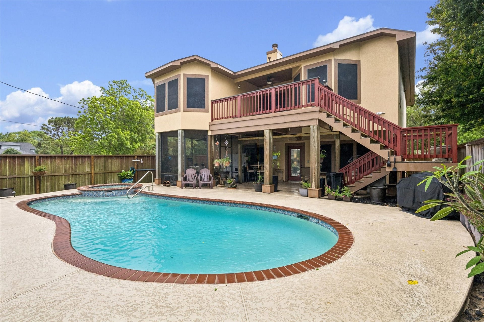 3040 Bayshore Drive, Bacliff, TX 77518 Private backyard with heated pool and spa, surrounded by plenty of patio for outdoor entertaining. Elevated deck with secondary stair access to the upstairs, overlooks the pool with covered seating area below adding shade and flaxibility.