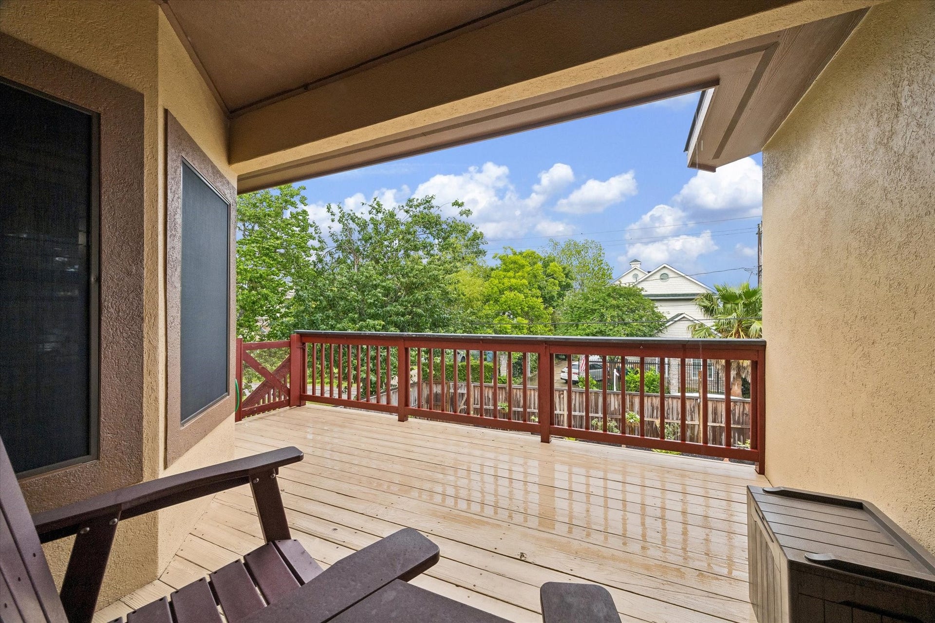 3040 Bayshore Drive, Bacliff, TX 77518 Spacious covered upper deck with wood flooring and railing, offering elevated views of the backyard and surrounding greenery. Ideal for outdoor seating, dining, or relaxing with direct access to the main living area.
