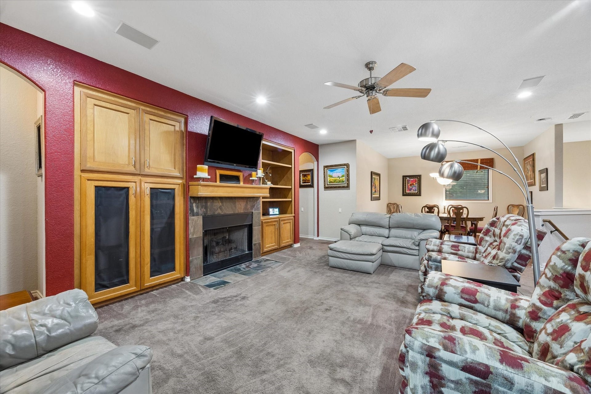 3040 Bayshore Drive, Bacliff, TX 77518 Open-concept living area with built-in cabinetry, fireplace, and media center. Spacious layout flows into the dining area, offering flexible seating and comfortable everyday living.