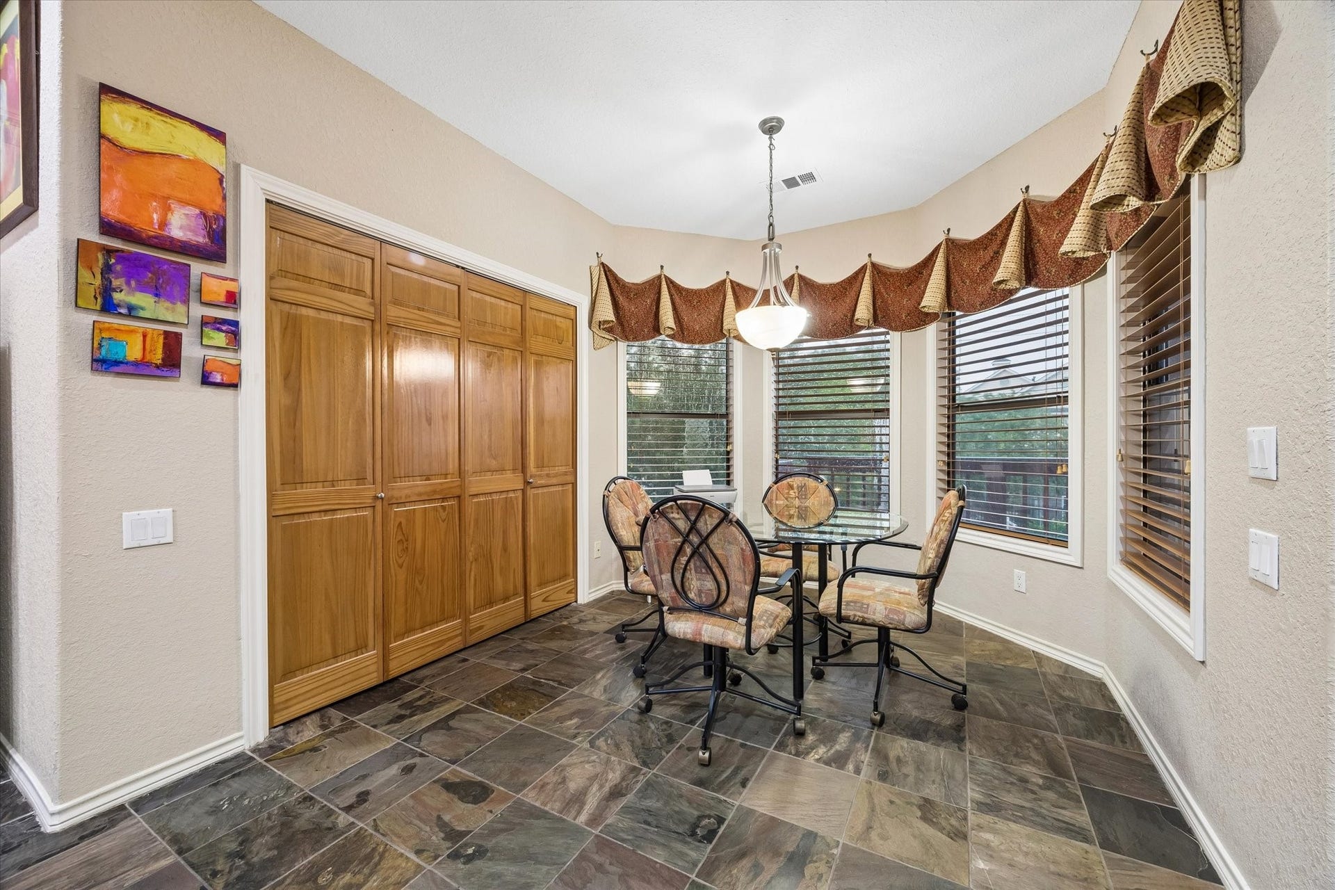 3040 Bayshore Drive, Bacliff, TX 77518 Bright breakfast area with bay windows providing natural light and backyard views. Ideal space for casual dining, with adjacent built-in storage and easy access to the kitchen.