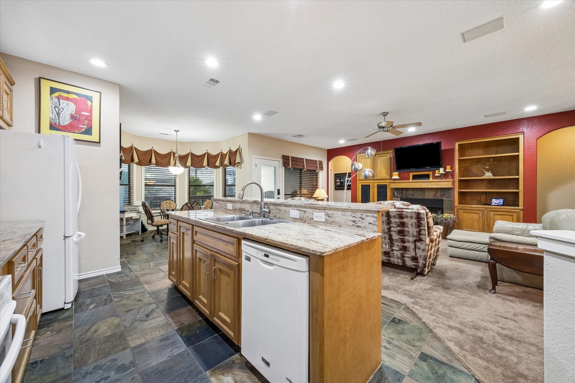 3040 Bayshore Drive, Bacliff, TX 77518 Spacious kitchen with large center island, double sink, and extensive cabinetry for storage. Open to the living area with adjacent breakfast space, providing functional flow for daily use and entertaining.