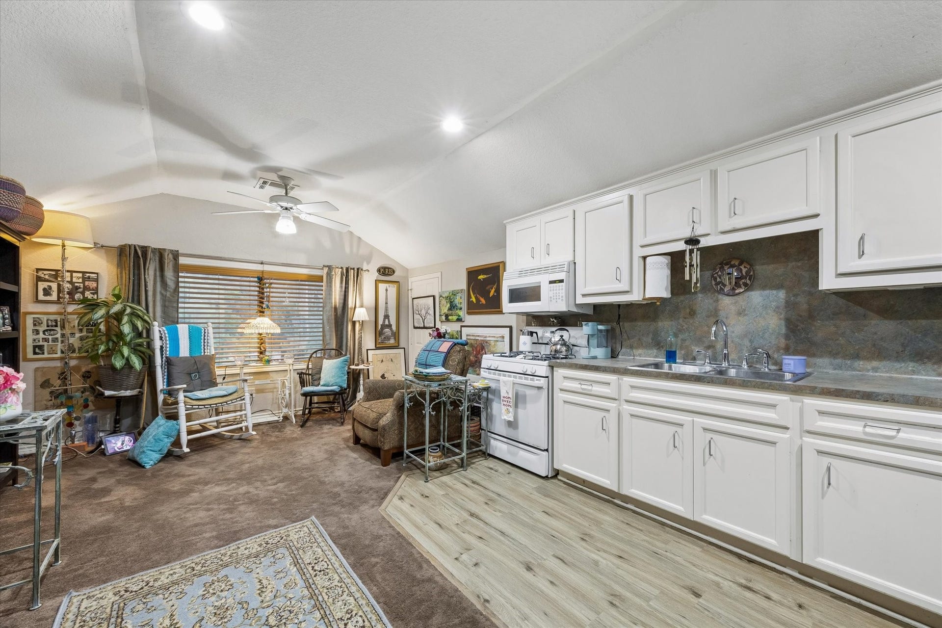 3040 Bayshore Drive, Bacliff, TX 77518 Secondary view of the garage apartment showcasing full kitchen with ample cabinetry and open living area. Vaulted ceiling and flexible layout support or guest accommodations.