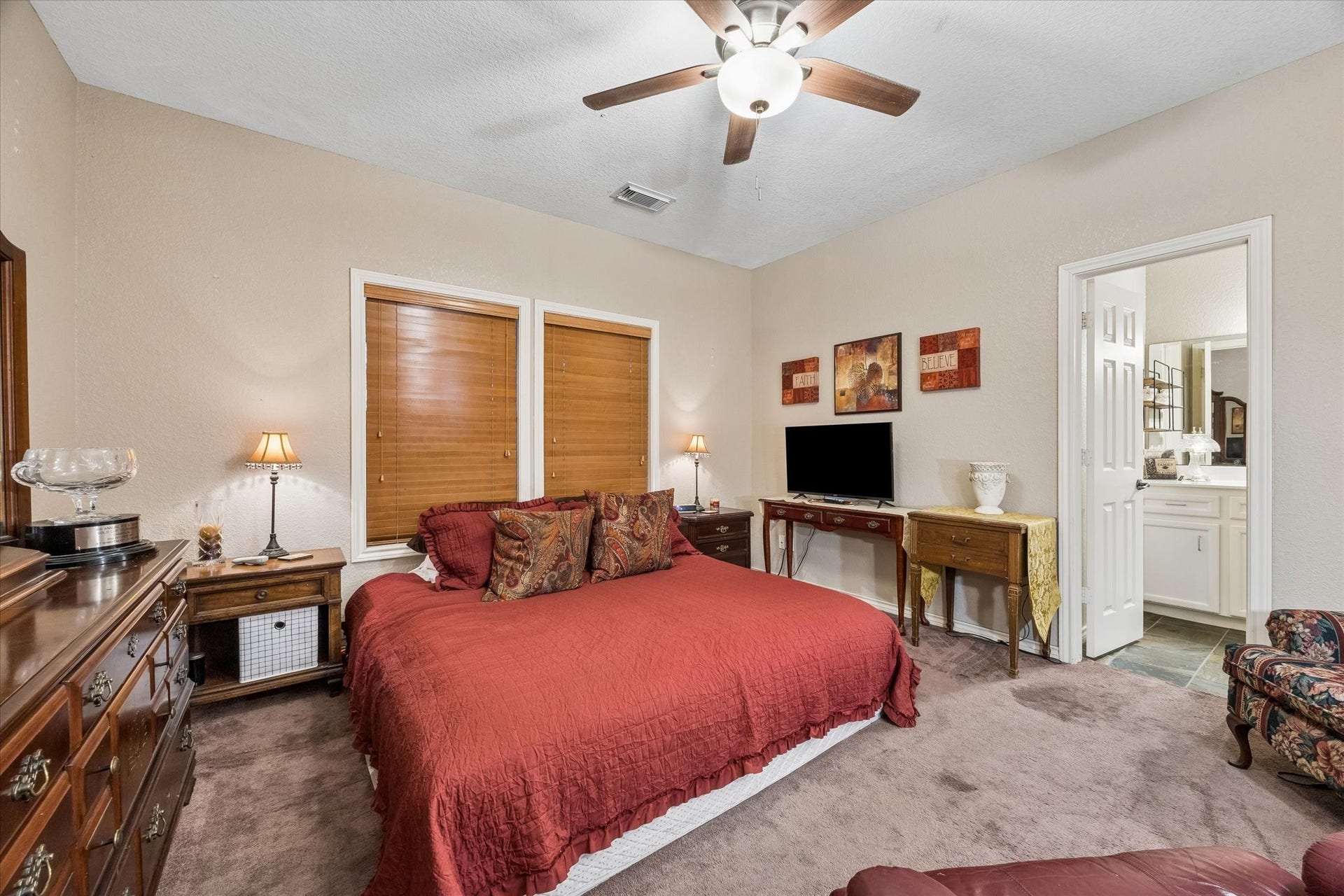 3040 Bayshore Drive, Bacliff, TX 77518 Downstairs bedroom/unit with ceiling fan and natural light, featuring a private en-suite bathroom with walk-in shower. Ideal for guests, multigenerational living, or private rental use.