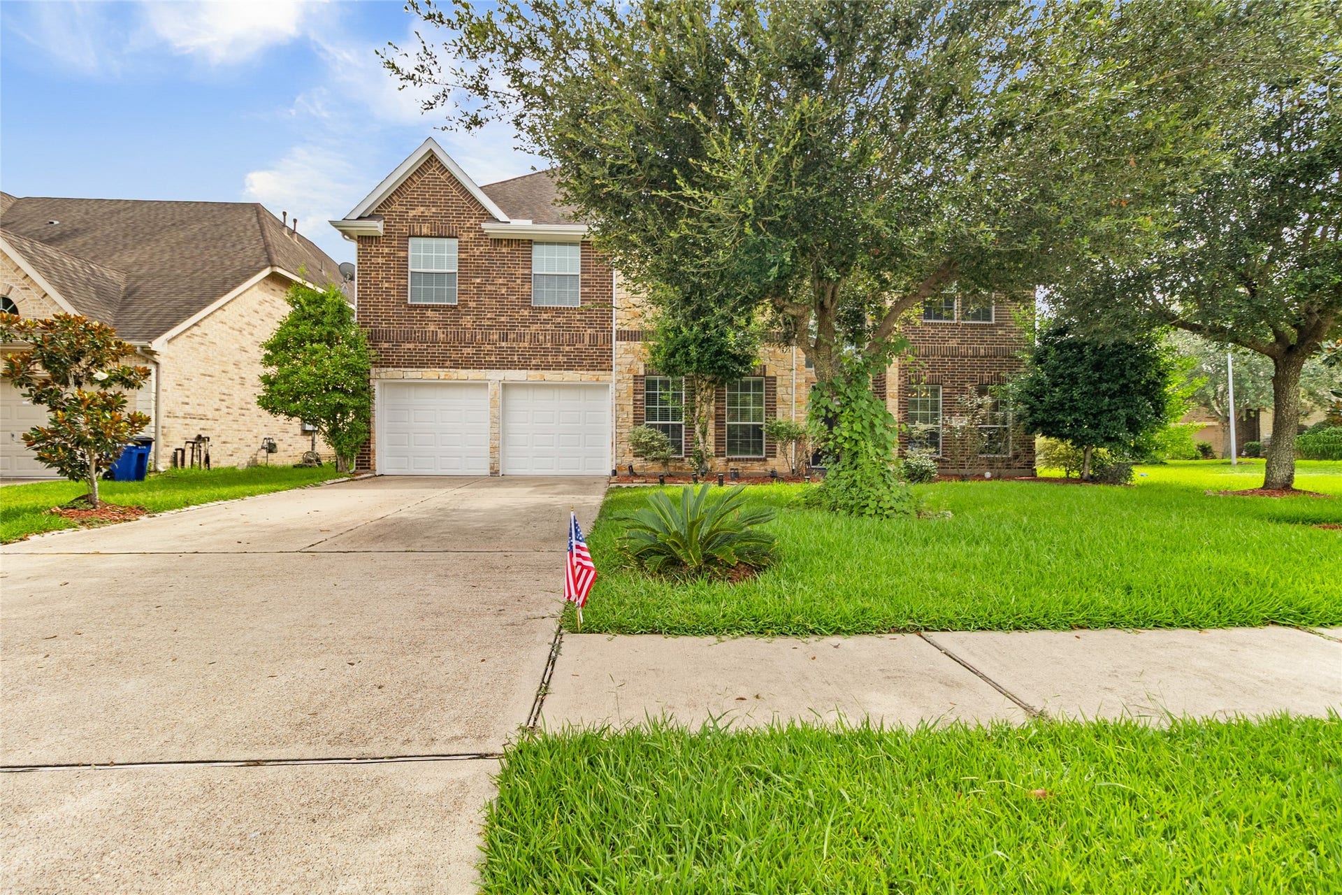 1231 Abigail Lane, Friendswood, TX 77546 Coming home feels inviting with mature shade trees, a wide driveway, and timeless brick-and-stone curb appeal.
