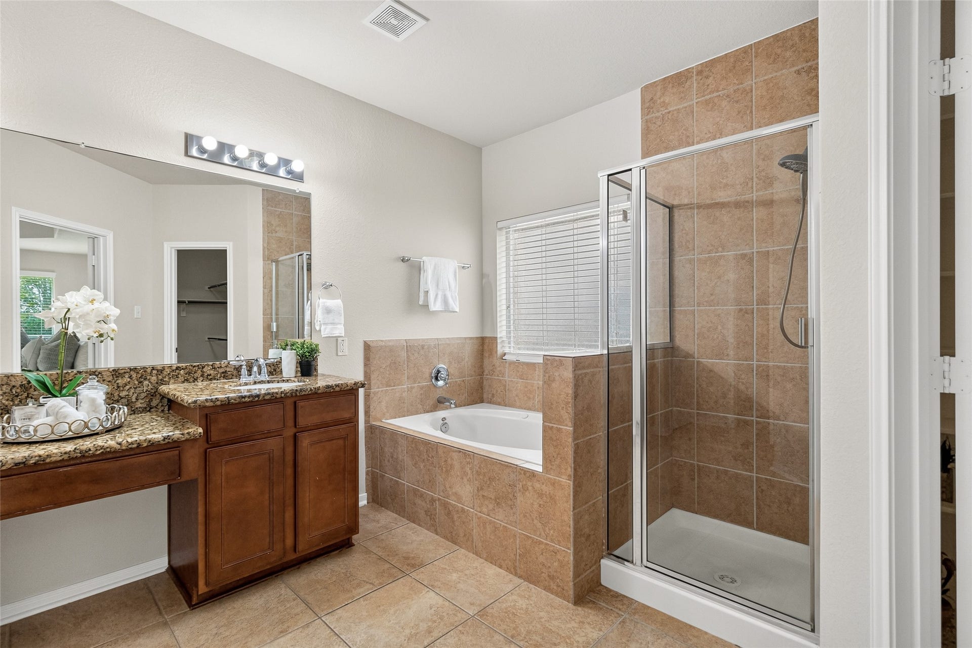 1231 Abigail Lane, Friendswood, TX 77546 Your luxurious primary bath features a soaking tub, separate glass-enclosed shower, dual vanities, and direct access to the oversized walk-in closet.