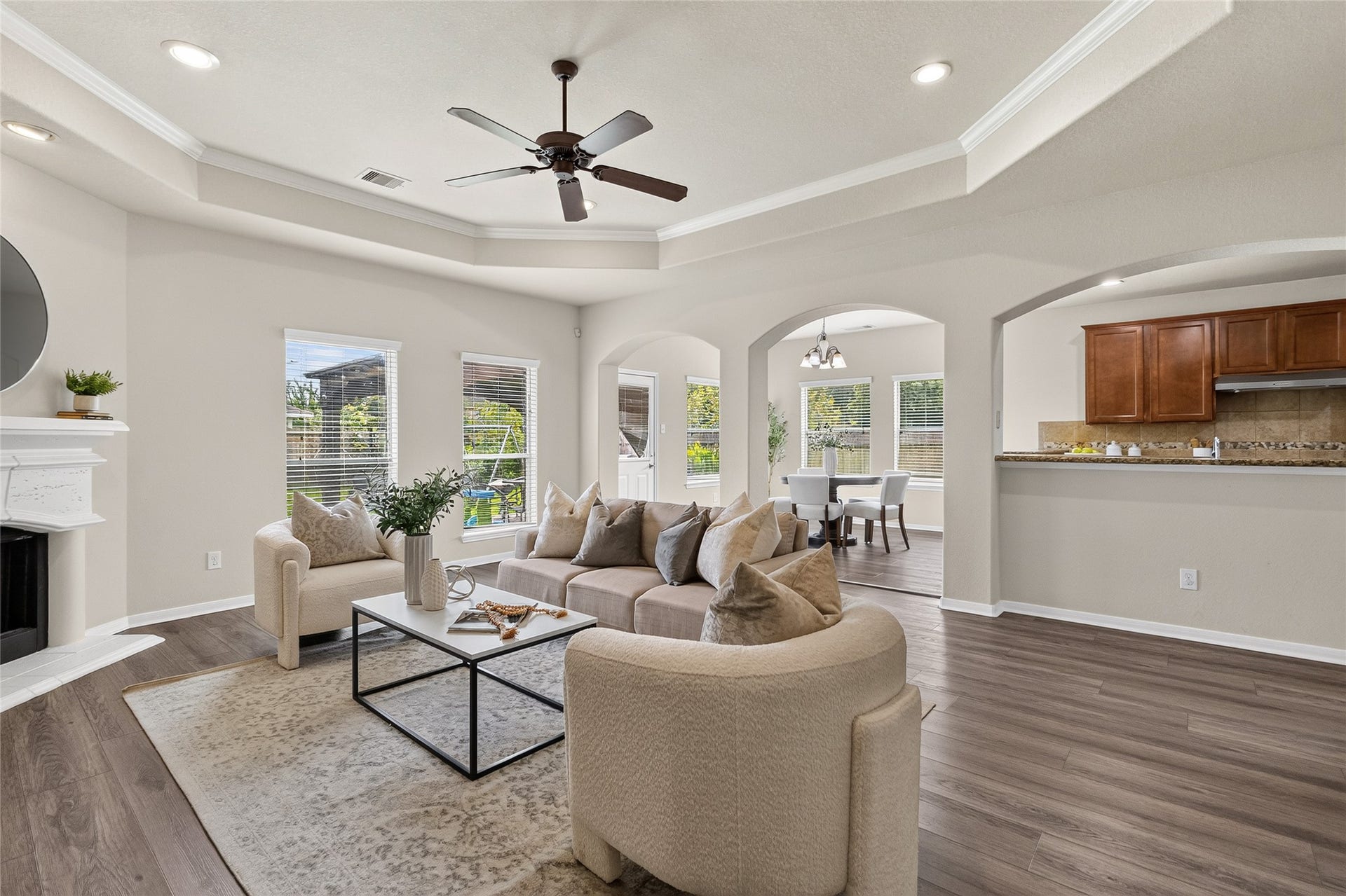 1231 Abigail Lane, Friendswood, TX 77546 Step into your inviting living room, where soaring tray ceilings, abundant natural light, and an open layout create the perfect space to relax, entertain, and stay connected to the heart of your home.