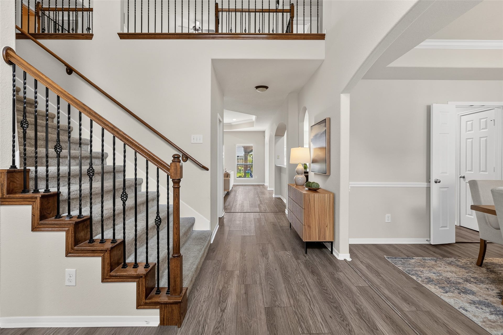 1231 Abigail Lane, Friendswood, TX 77546 A grand two-story entry with soaring ceilings, elegant wrought-iron staircase, and rich flooring creates an impressive welcome every time you walk through the front door.