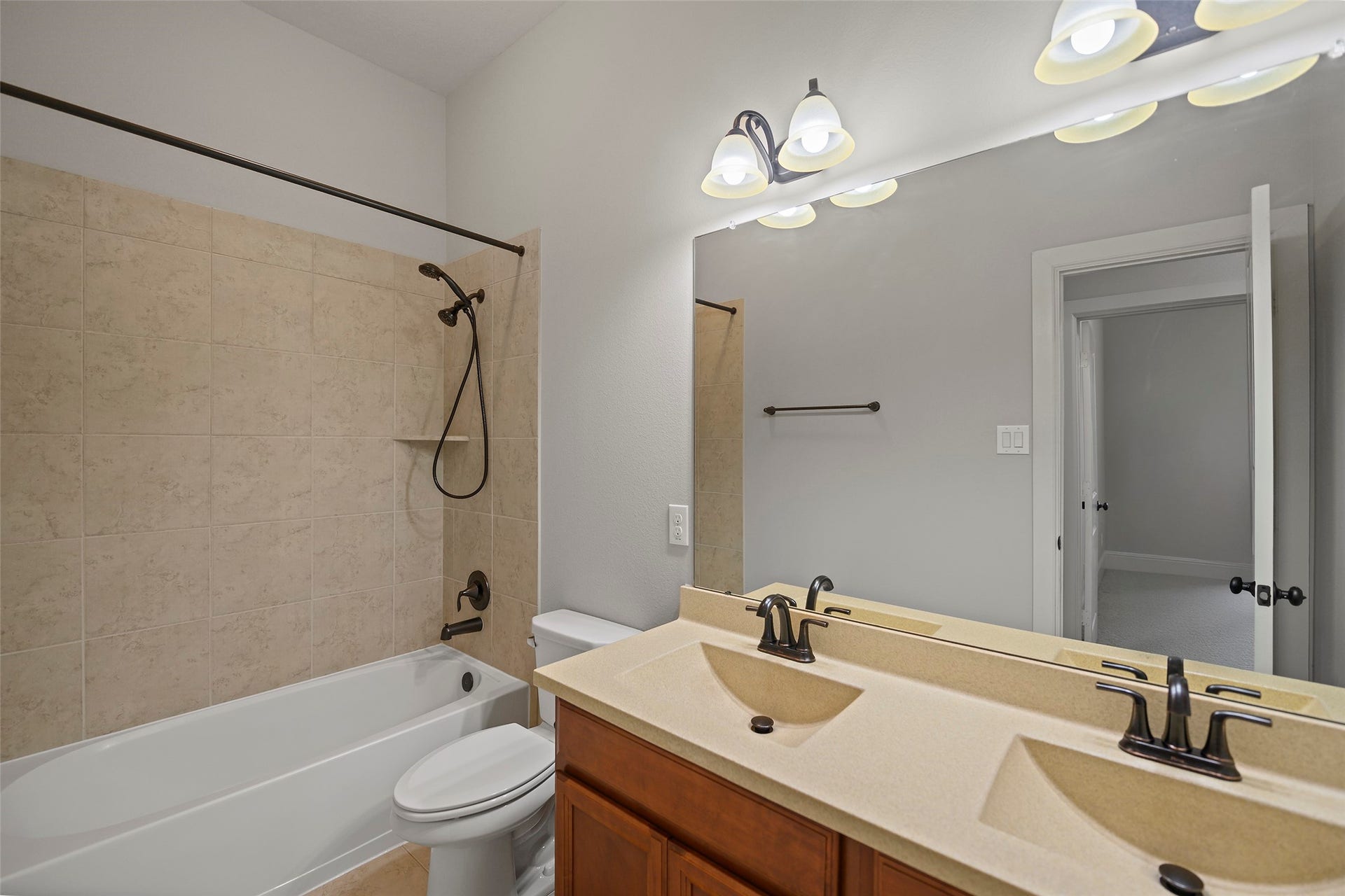 Full bathroom with dual sinks and shower/tub combo shared by the secondary bedrooms.