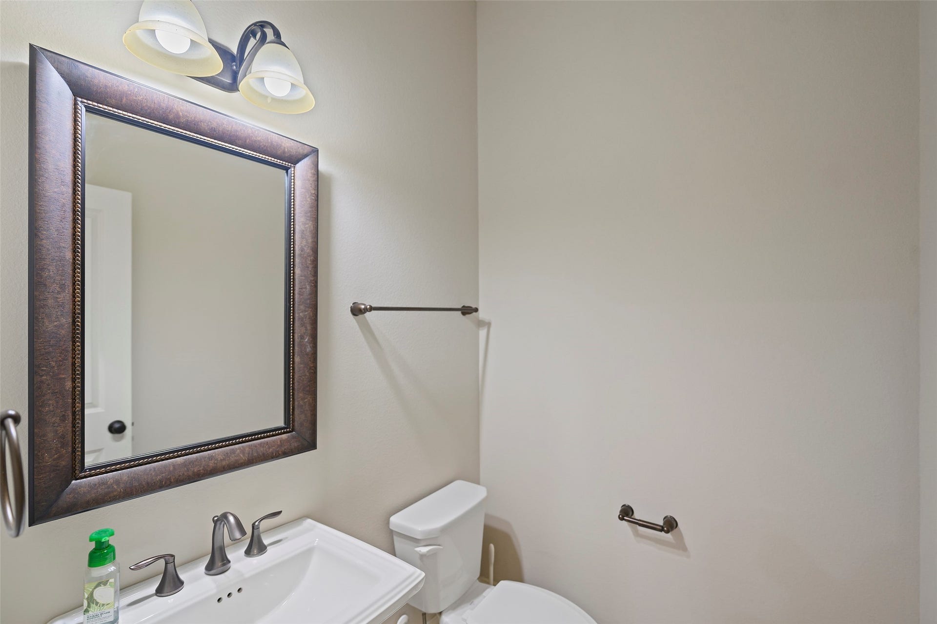 Downstairs half-bathroom with pedestal sink.