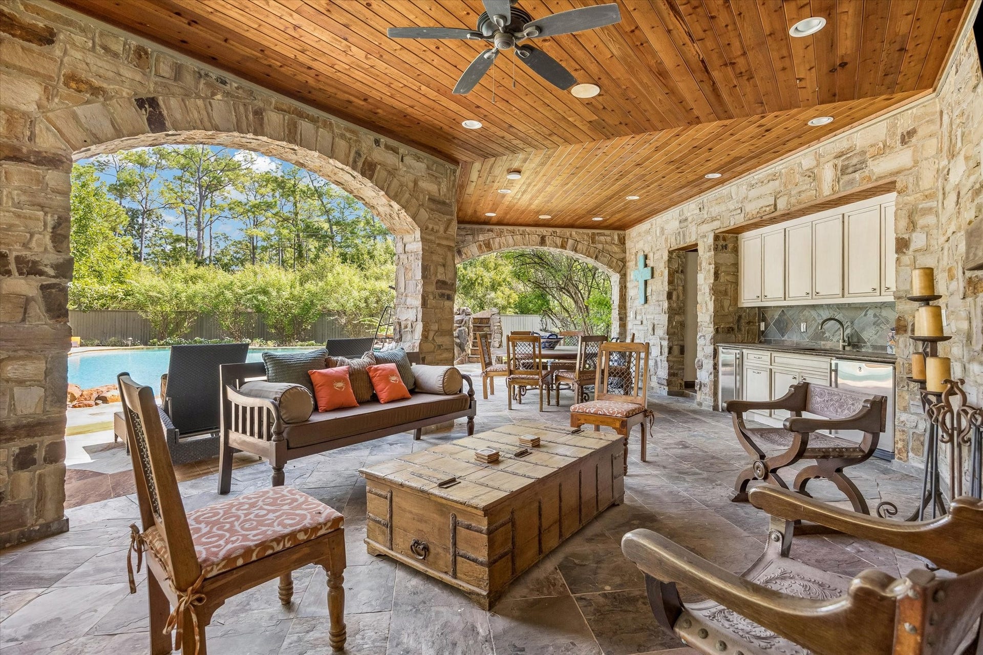 34 Liberty Bell Circle, Bunker Hill Village, TX 77024 Designed for relaxing and entertaining, the separate pavilion features graceful stone archways, a wood-plank ceiling, and generous covered space for dining and gathering by the pool.