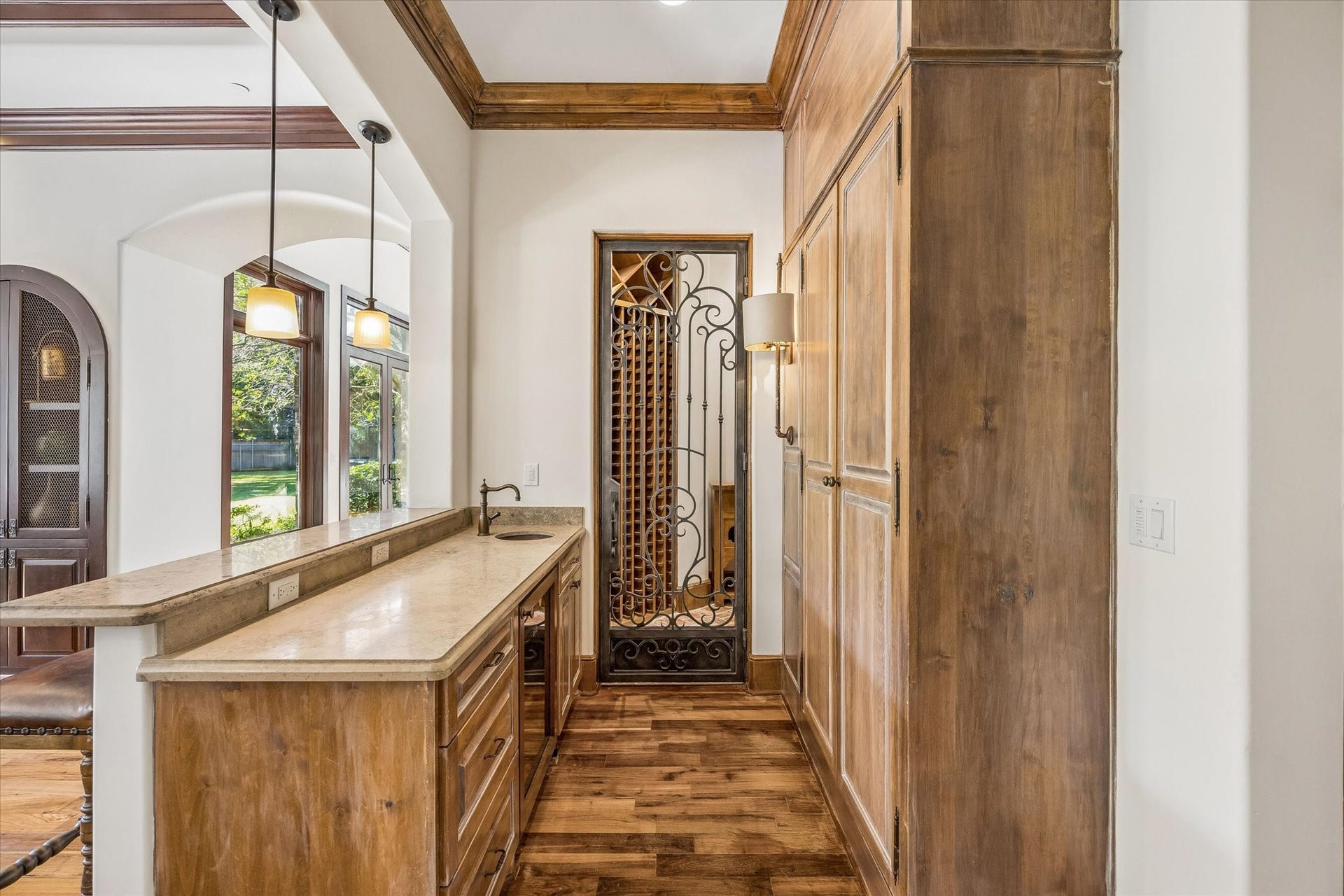34 Liberty Bell Circle, Bunker Hill Village, TX 77024 Just off the family room, a thoughtfully designed wet bar offers convenient serving space and direct access to a wine room through an elegant wrought iron door.