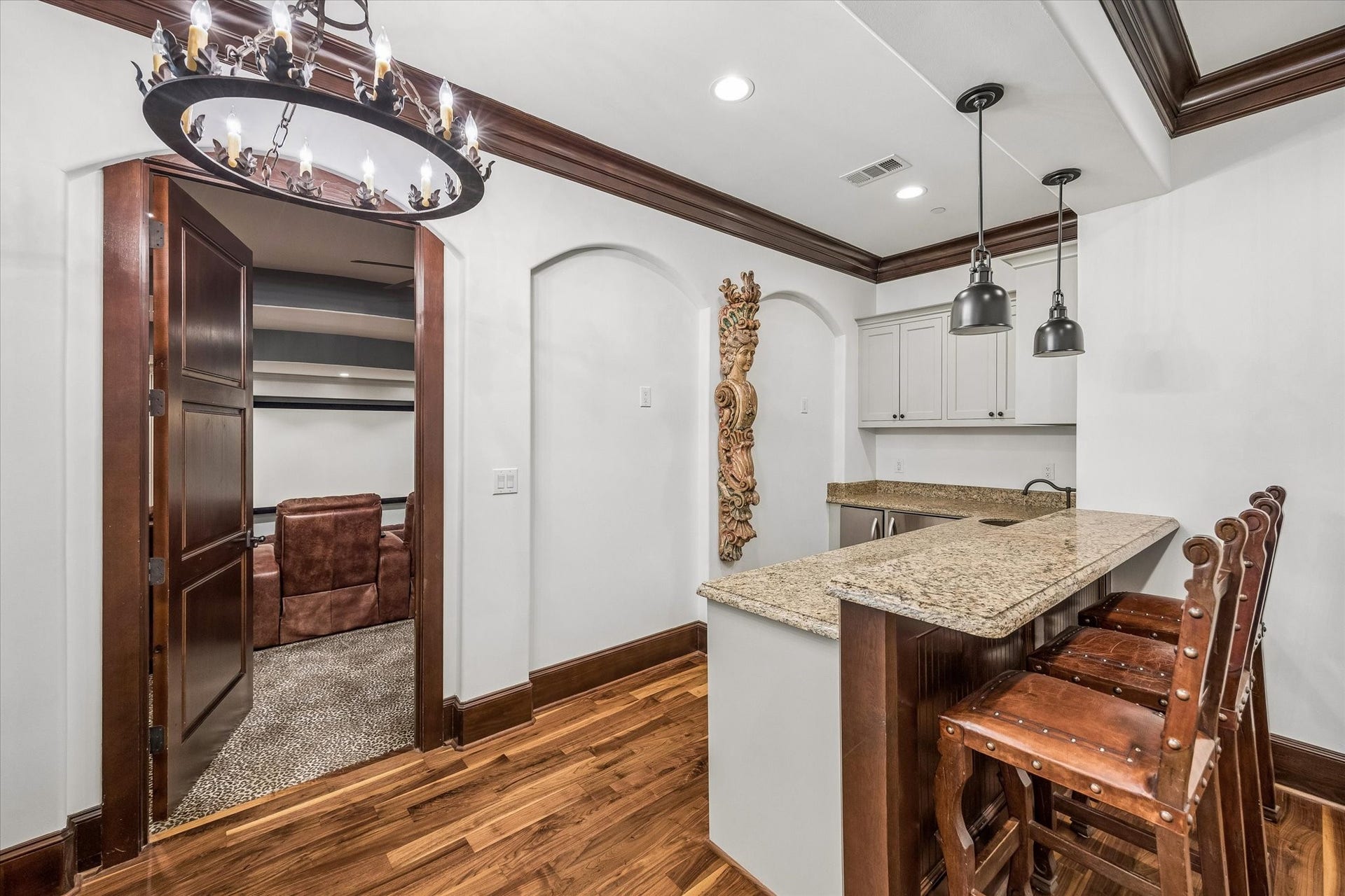 34 Liberty Bell Circle, Bunker Hill Village, TX 77024 Conveniently located between the media room and upstairs game room, this bar area features granite countertops, bar seating, a sink, and beverage storage for easy entertaining.