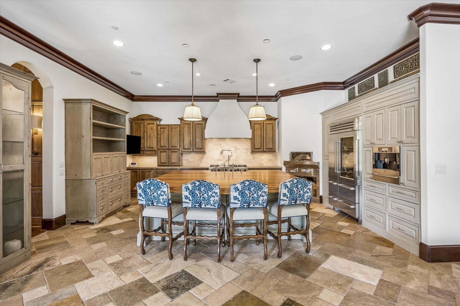 34 Liberty Bell Circle, Bunker Hill Village, TX 77024 Designed for cooking and gathering, the spacious kitchen features an oversized island with seating, a professional-style range, custom cabinetry, and a full wall of built-in appliances.
