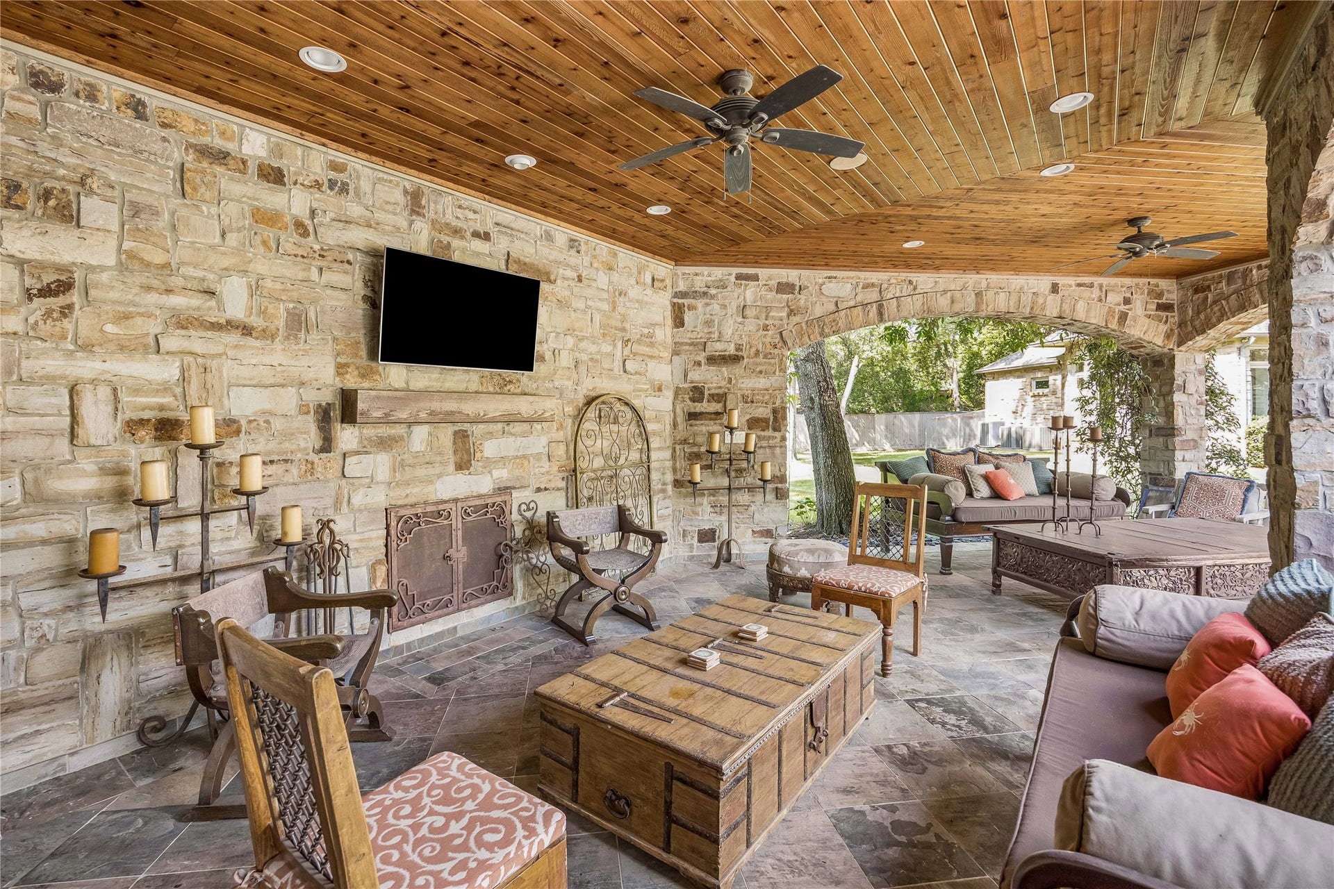 34 Liberty Bell Circle, Bunker Hill Village, TX 77024 A separate stone pavilion offers an inviting outdoor retreat with a beautiful fireplace, natural stone flooring, and a warm wood-plank ceiling.