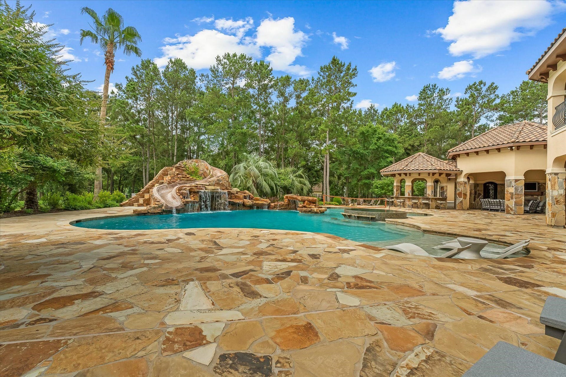 28322 Meadow Forest, Magnolia, TX 77355 Zero edge spa with swim-up seating and dedicated water sports area.