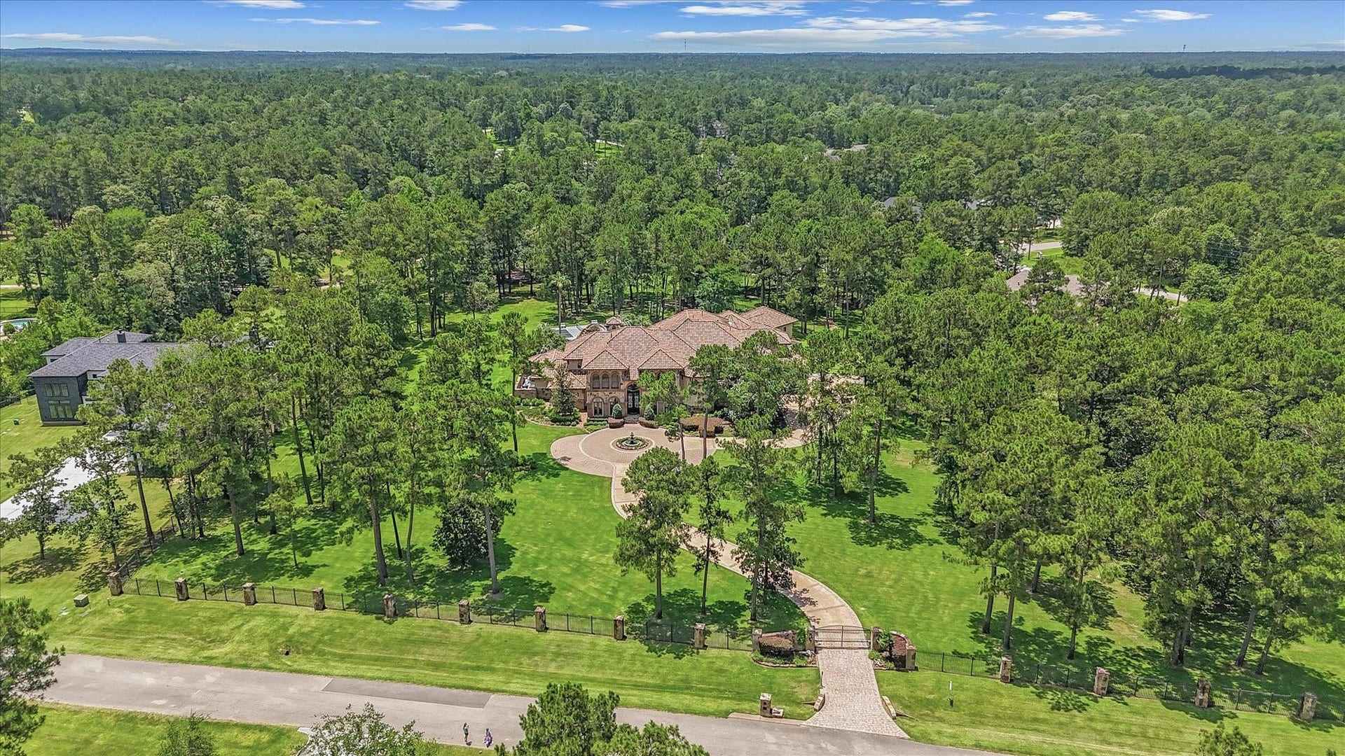 28322 Meadow Forest, Magnolia, TX 77355 Fully Gated 4.16 Acres with full Exterior Surveillance Cameras system. Custom stain concrete Driveway with stone pavers. Newly reconstructed concrete fountain.