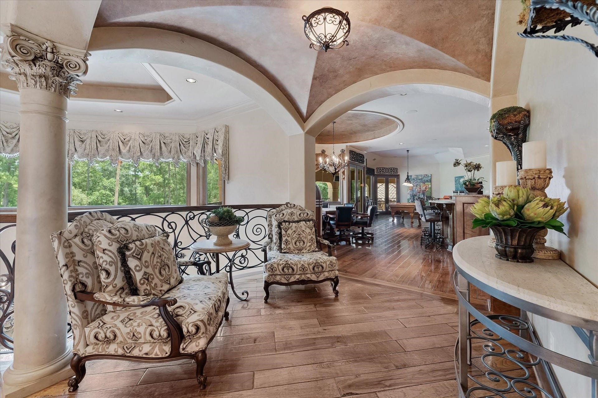 28322 Meadow Forest, Magnolia, TX 77355 Venetian plaster dome ceiling with custom chandeliers with Custom Tray Ceiling With Cove Lighting, Recessed Speakers, and Recessed Lighting.