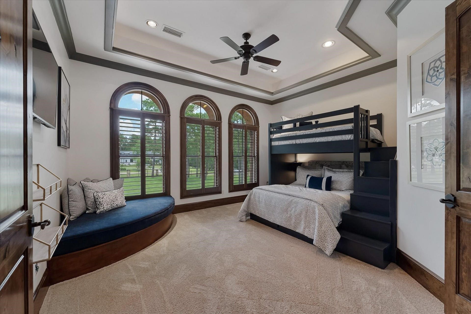 28322 Meadow Forest, Magnolia, TX 77355 Guest bedroom #2 on the 2nd floor. Dual Mahogany Door Entry, Custom Built-in Bunk Beds with custom built-in corner bench. Three large arched windows with custom wood shutters provide northern exposures and a view of the front yard. Custom crown molding, Custom Tray Ceiling With Cove Lighting.