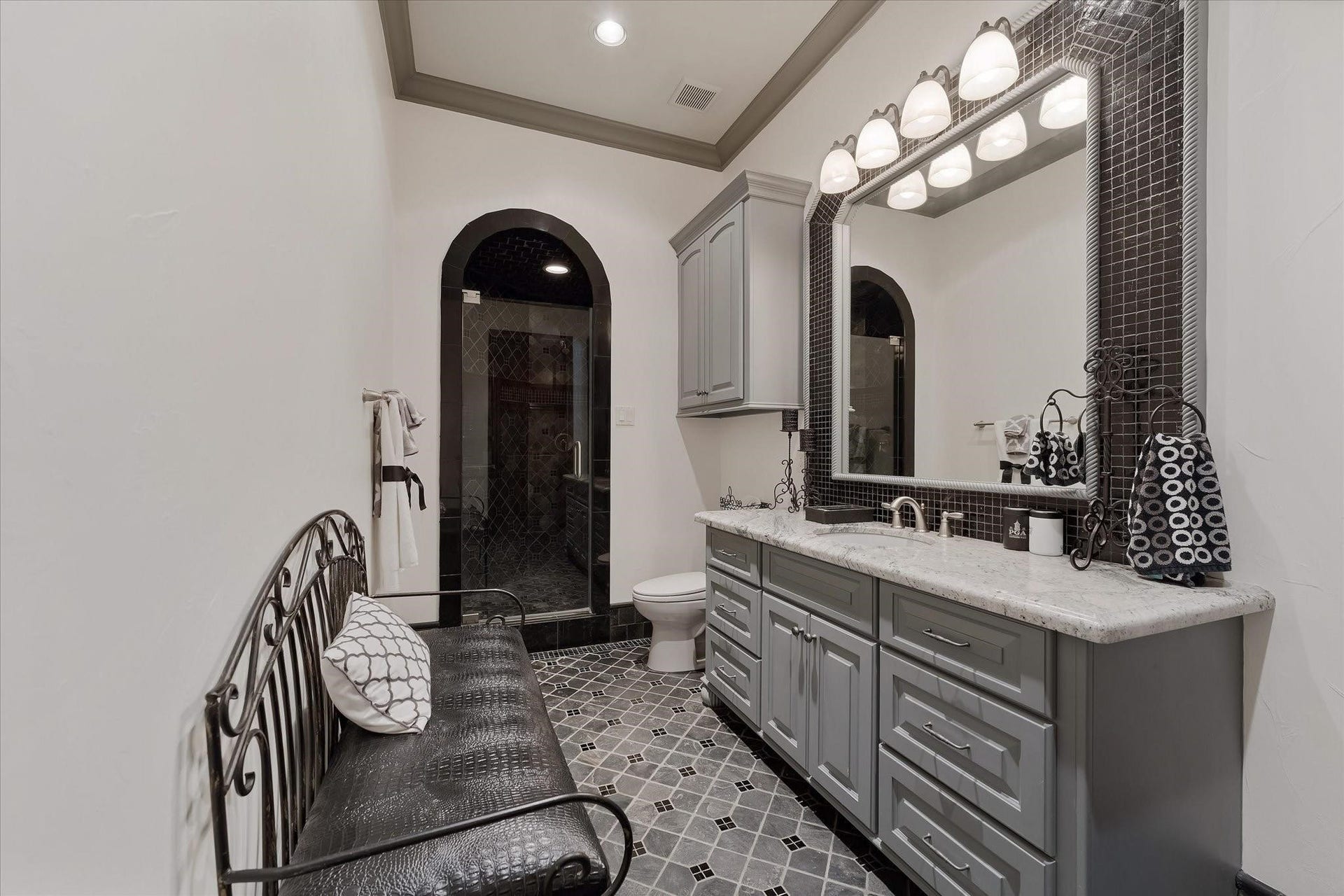28322 Meadow Forest, Magnolia, TX 77355 Guest bedroom ensuite #3 on the second floor.
Custom tile flooring with an intricate pattern, a shower with a built-in bench. Alpine granite countertop vanity with Custom framed mirror. Walk-in Closet With built-ins and a window providing northern exposures and views of the front yard, door Jamb Light Switch.