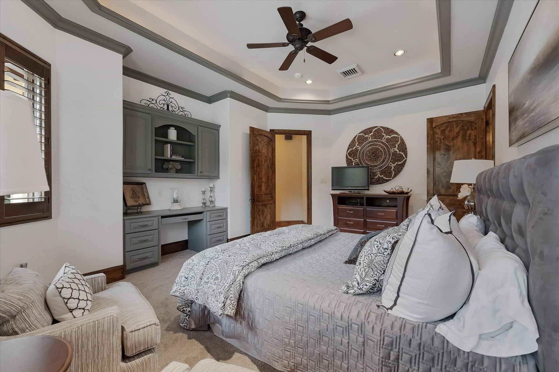 28322 Meadow Forest, Magnolia, TX 77355 Guest Bedroom #3 on the second floor. Includes built-in desk with custom cabinetry that offers lower closed storage and open shelving. Windows offer views of the backyard and southern exposures.