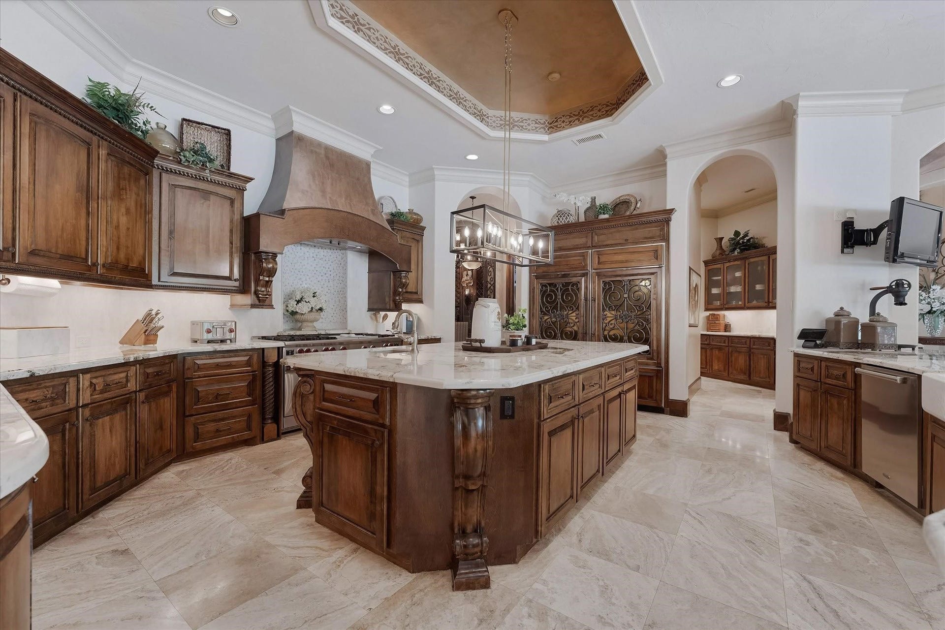 28322 Meadow Forest, Magnolia, TX 77355 The kitchen boasts a 60" gas range with double ovens, warming drawer, two full-sized stainless dishwashers, a stainless steel ice maker, and dual Sub-Zero refrigerators with freezer drawers. The oversized walk-in pantry features a full-size SubZero refrigerator. Alpine granite countertops, an oversized center island, recessed speakers and lighting, pendant light fixtures, custom crown molding, travertine floors, a tray ceiling with cove lighting, and under-cabinet lighting.