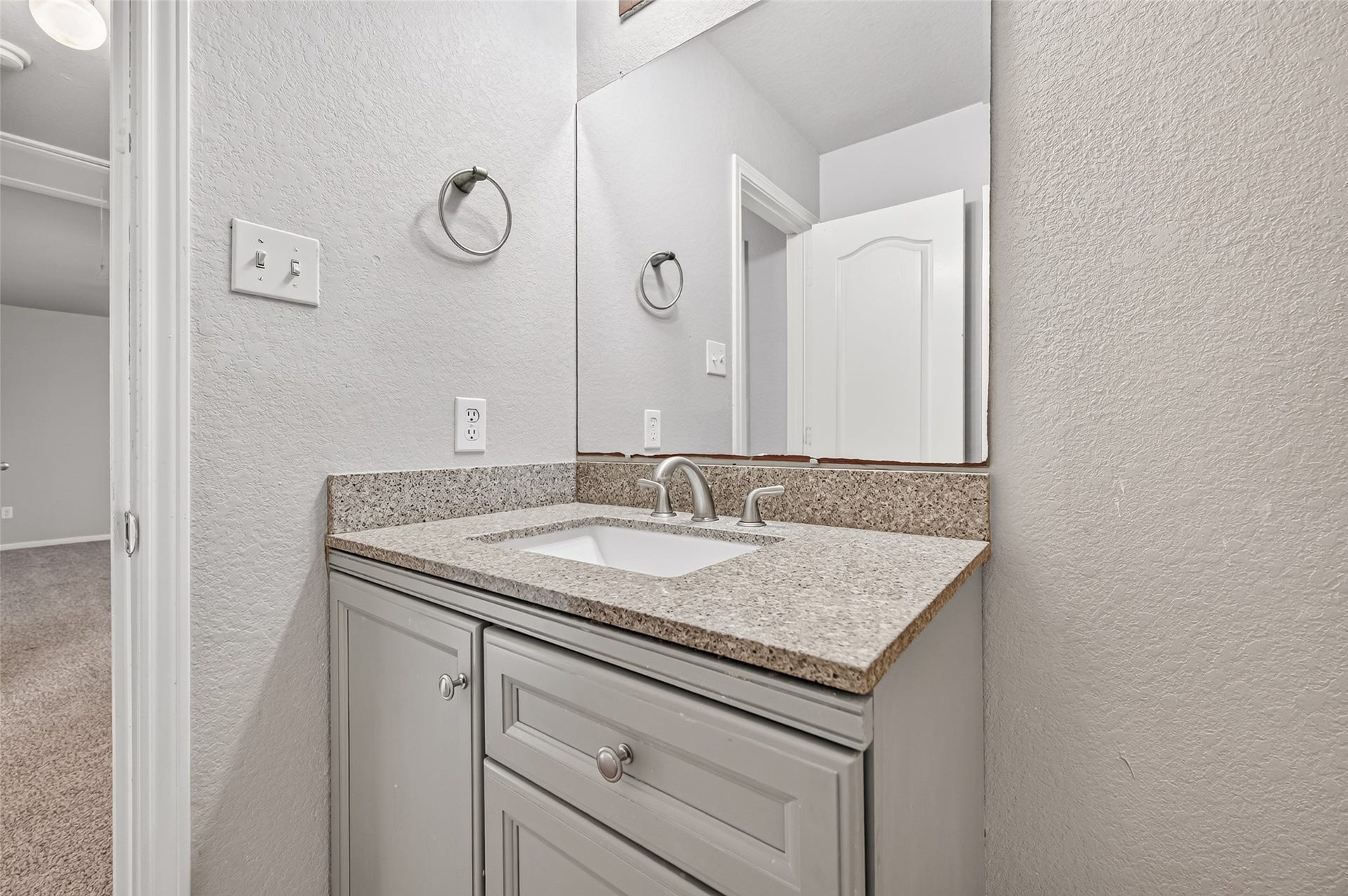 19707 Dayton Springs Drive, Cypress, TX 77429 Stylish bathroom vanity with sleek granite countertop, modern fixtures, and ample cabinet storage.